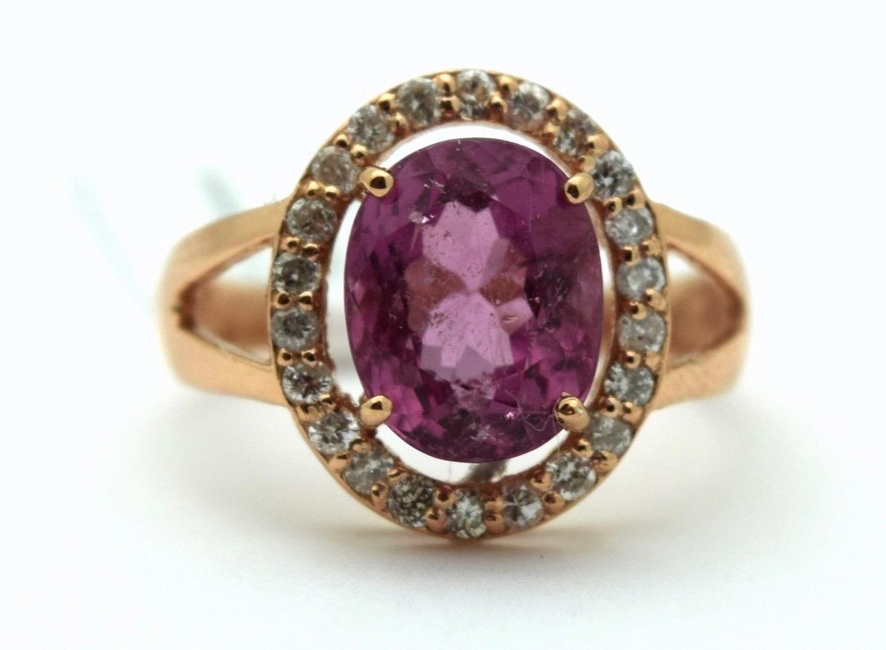 Pink tourmalines are so beautiful esecially when accomapanied by a diamond halo, this is a modern diamond ring with a hot pink center in 14KT rose gold. The diamonds are weighing 0.50 carats and are SI clarity and F-G color. The tourmaline is