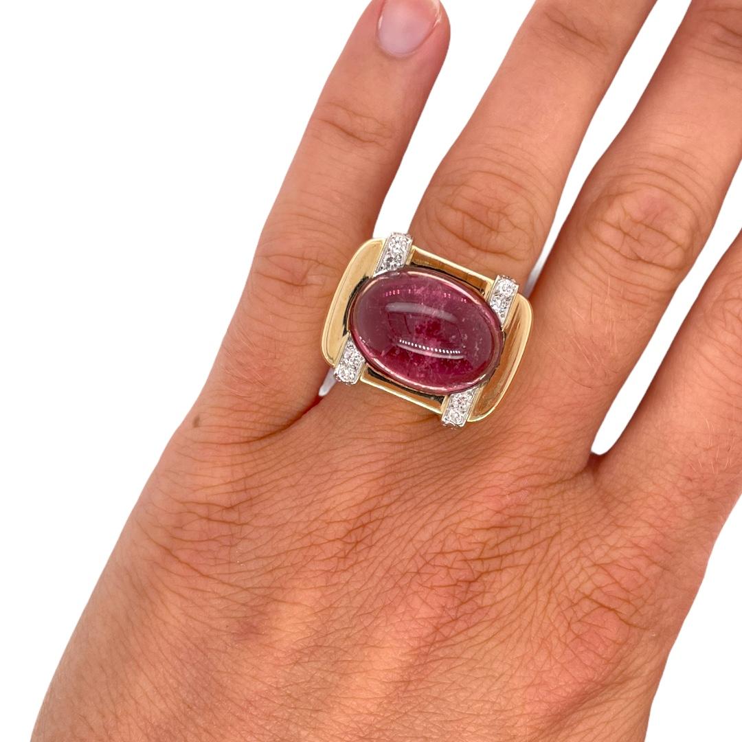 Ring contains 1 oval shape cabochon cut pink tourmaline, approximately 10.00ct and 20 round brilliant diamond accents, approximately 0.75tcw. Diamonds are G in color and SI1 in clarity, mounted in a white gold setting. Center stone is mounted in a