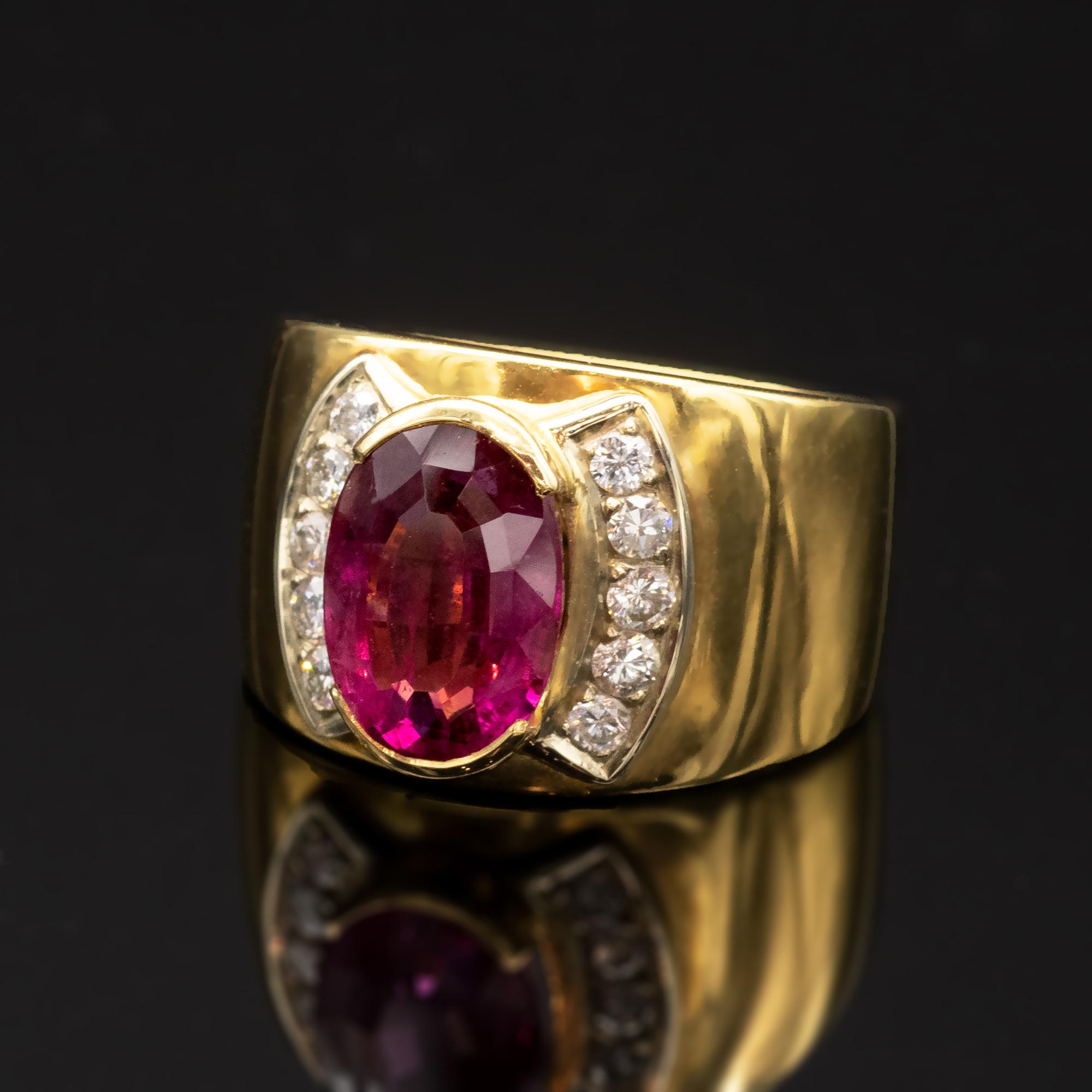 Elegant Pink Tourmaline and diamonds cocktail ring: A wide band of polished 18 Karat yellow gold with in its middle a lively oval pink tourmaline weighing 3.74 carat encompassed with ±0.34 carat of diamonds set on white gold. 