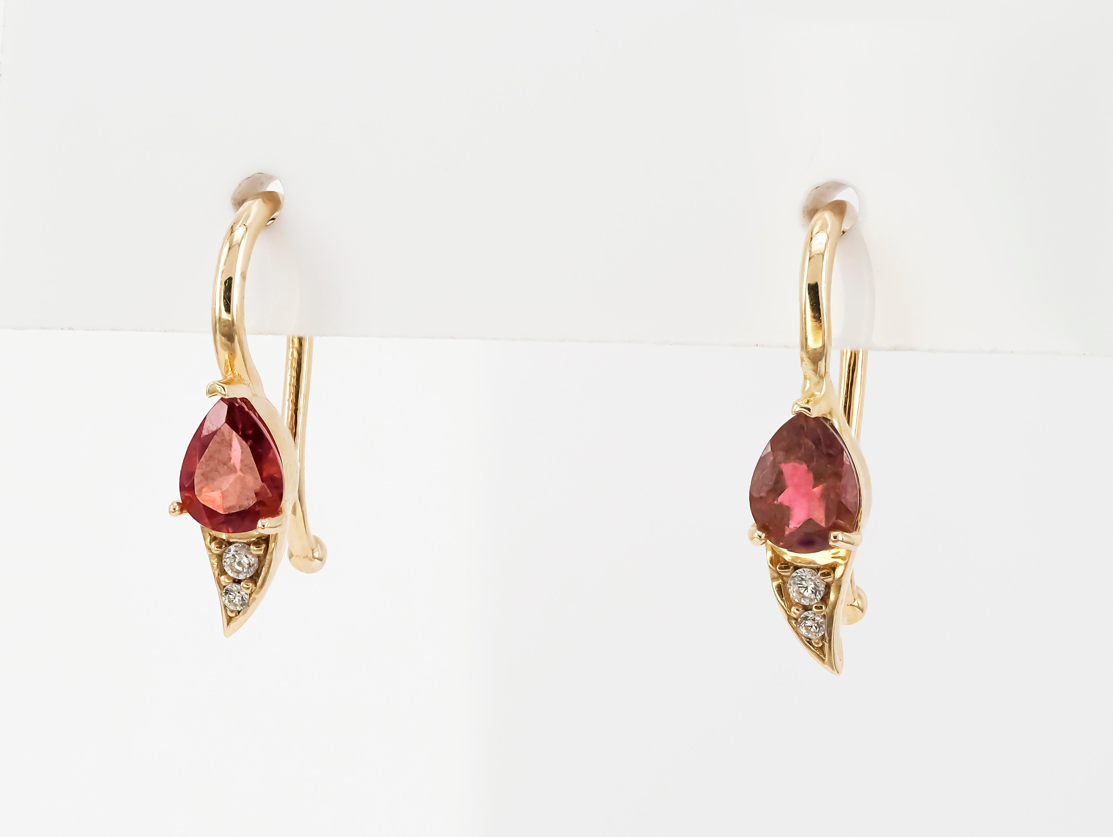 14 k yellow gold earrings with pear tourmalines and diamonds. Tiny gold earrings.

Metal: 14k yellow gold
Weight: 1.80 g.
Size: 16.5x4.5 mm
Set with tourmalines, color - pinkish red
Pear cut, 1.8 ct. in total.
Clarity: Transparent with