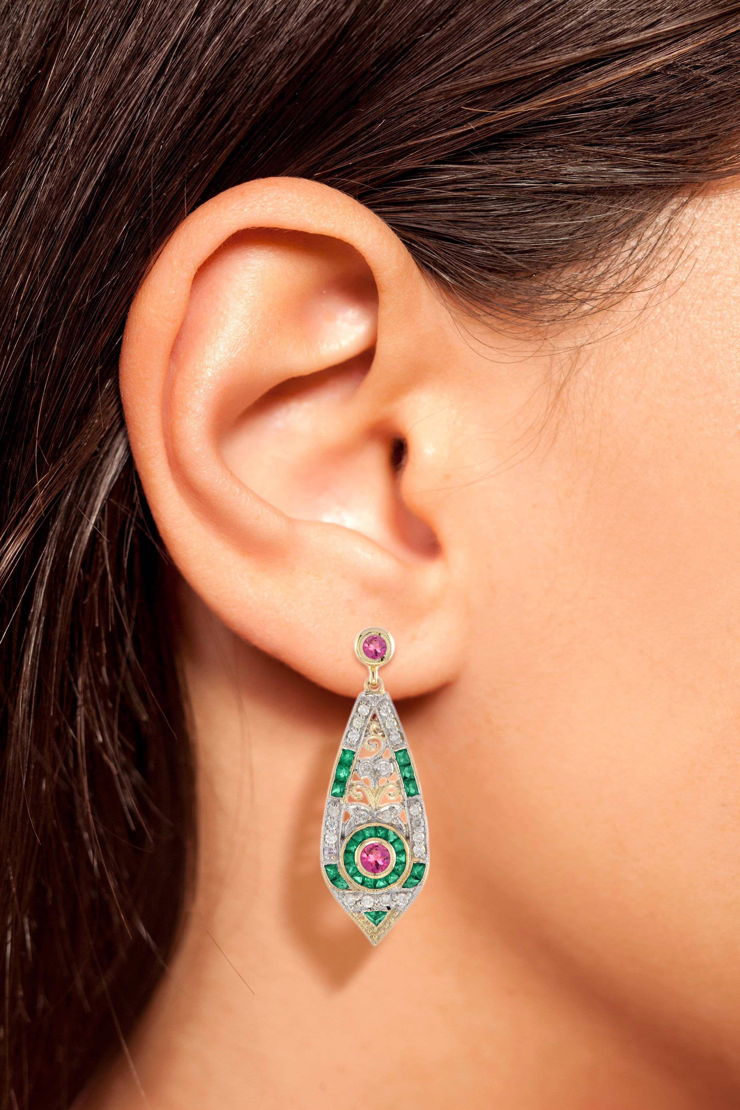 This is an exquisite pair of opal drop earrings with Art Deco ear design. The earrings feature a geometric design which is set with pink tourmaline for their centers, surrounded by French cut emerald and lovely sparkling diamonds, all set on 14k