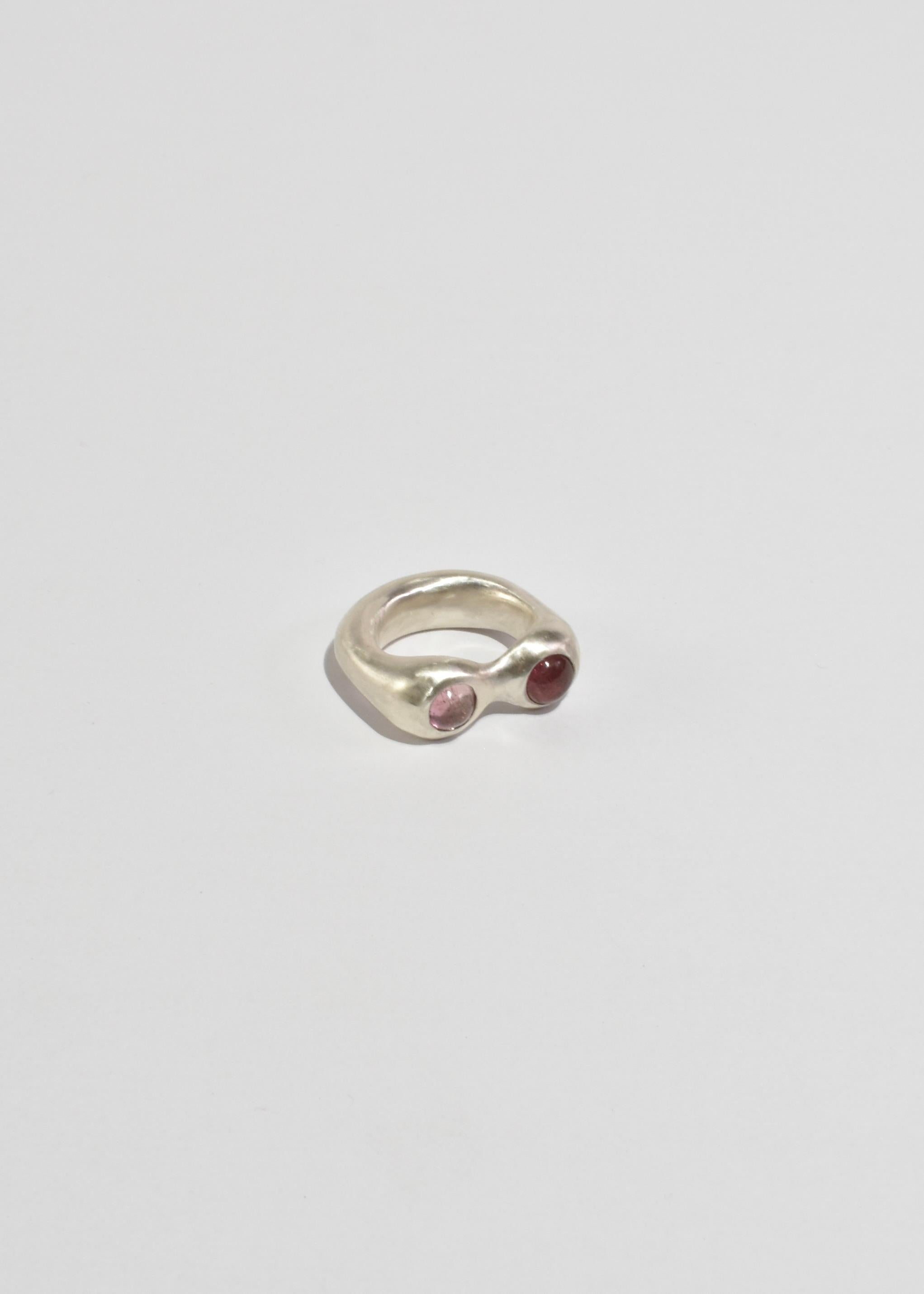 Sterling hand carved and cast organic shaped ring with two round tourmaline stones in varying pink tones.

Each piece is hand carved and finished in Virginia by Shauna Dunn of First Edition.

Material: Sterling silver, tourmaline.

We recommend
