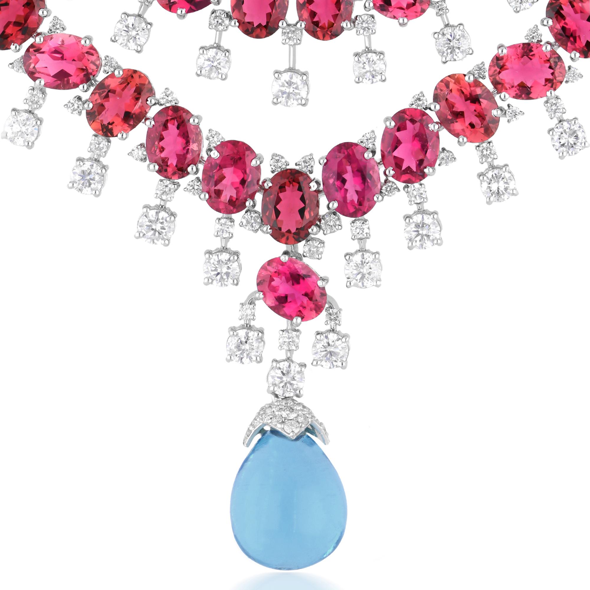 At the center of the necklace glistens a stunning Pink Tourmaline gemstone, radiating with a delicate hue that exudes femininity and grace. Surrounding the tourmaline are sparkling Diamonds, meticulously set to enhance its brilliance and allure. The