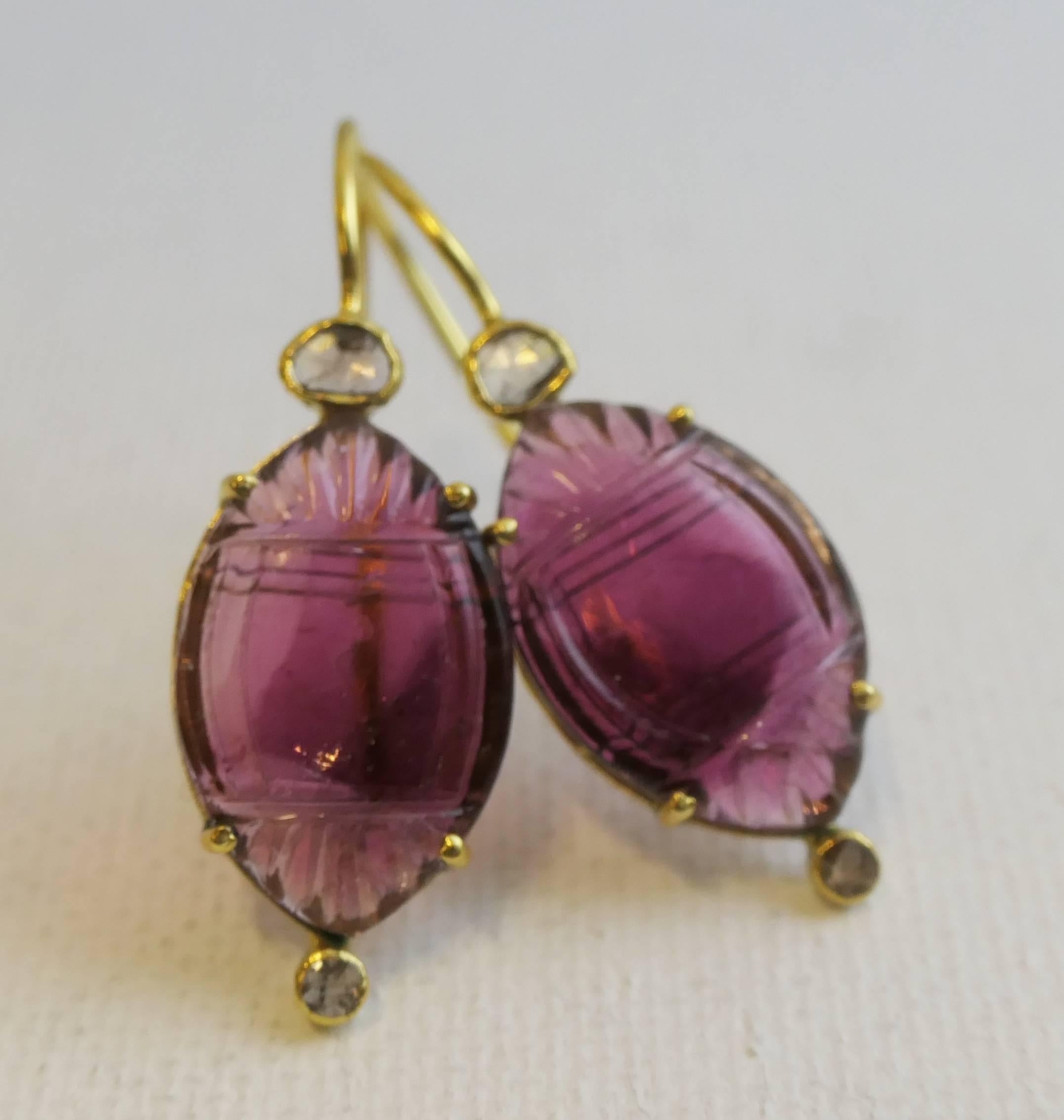 12x18mm Carved Pink Tourmaline are prong set in gold plated sterling silver.  There are two diamonds bezel set above and below the tourmaline.  Top one is approximately 3mm, while the bottom one is smaller at approximately 2mm.   
The length of