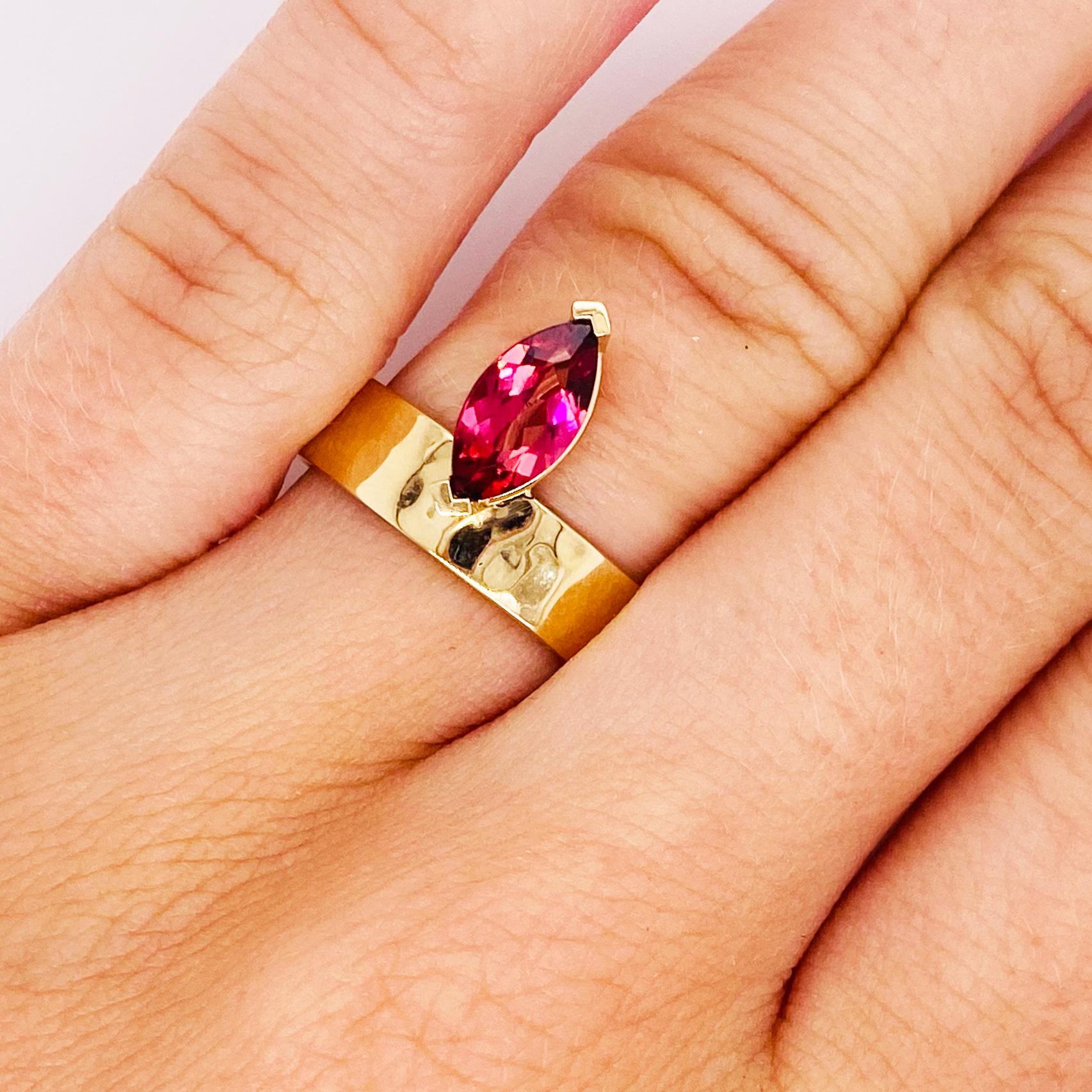 This off-set design is a 14k yellow gold band that is 5 millimeters(mm) wide with a gorgeous marquise pink tourmaline added to it. The genuine bright pink tourmaline is set in a secure basket setting. The band is hammered all the way around and the