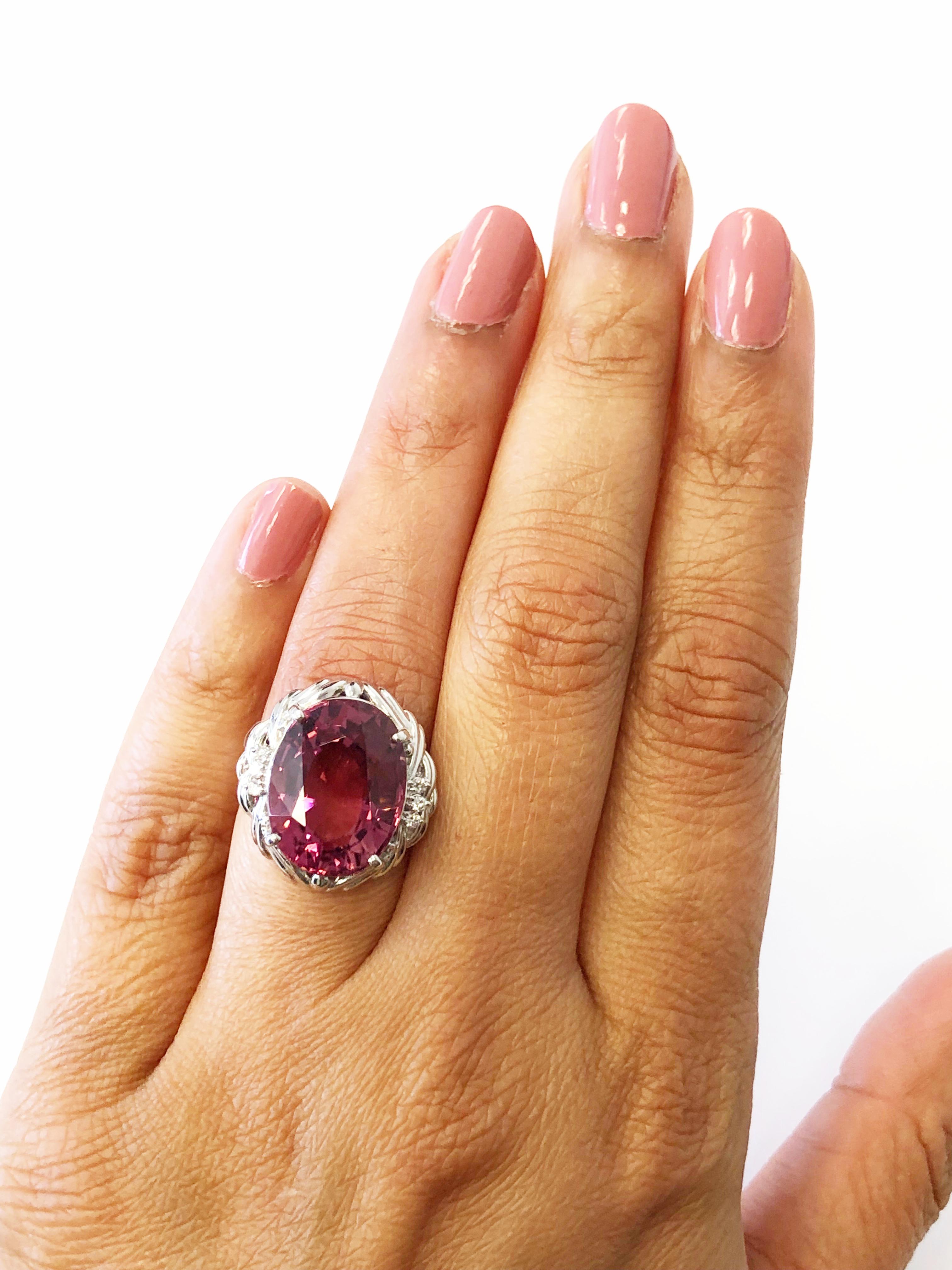 Gorgeous pink tourmaline oval with a rich and vibrant pink color weighing 13.55 carats.  This ring is handmade and has 0.08 carats of good quality white diamond rounds.  Platinum mounting size 5.75.  Perfect for someone who likes a big look and nice