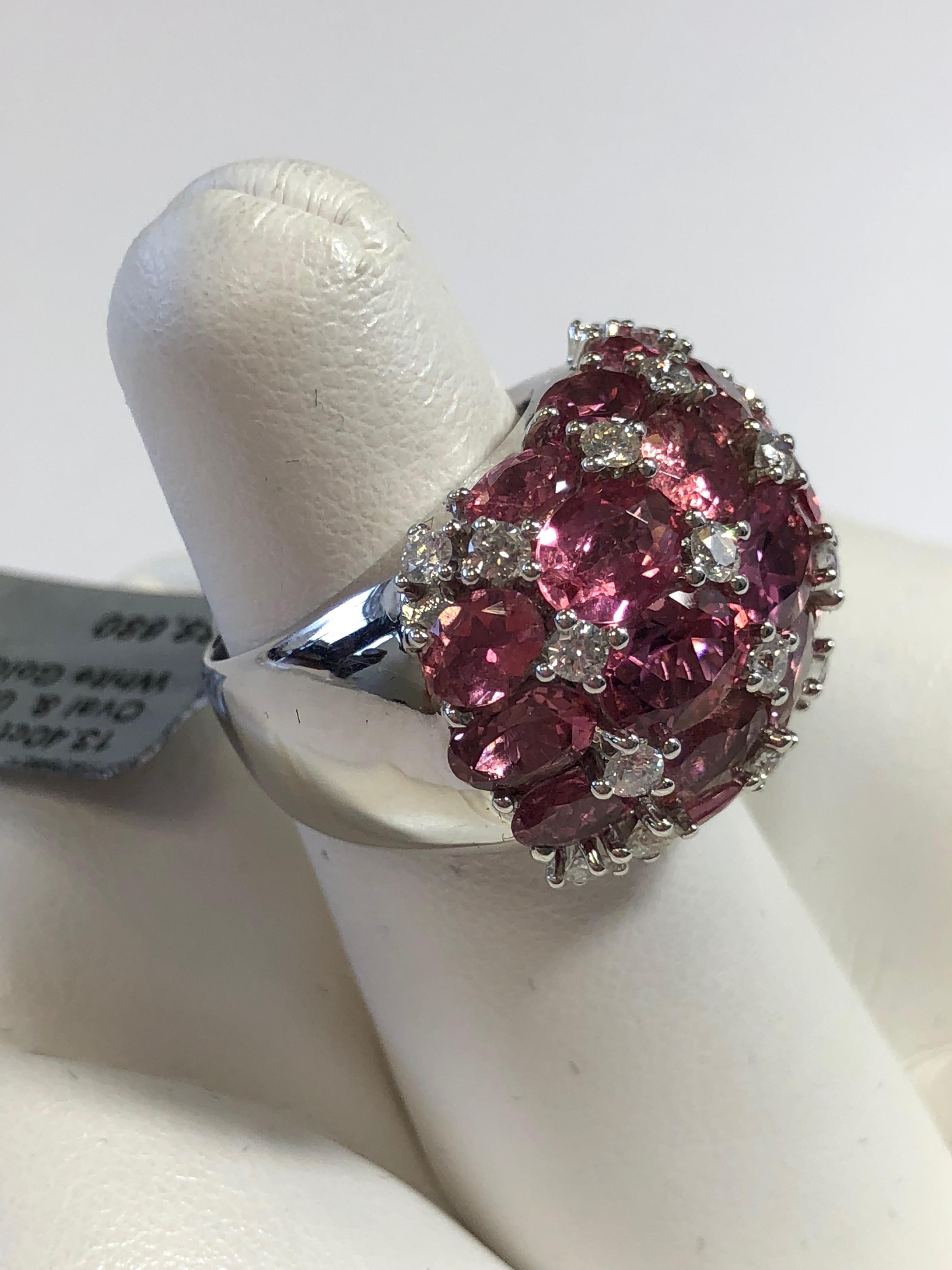 Gorgeous 13.40 carats of bright pink tourmaline ovals in different hues of pink with white diamond accents weighing 0.93 carats.  This beautiful 18k white gold ring is a size 6.25.  Perfect for any occasion!