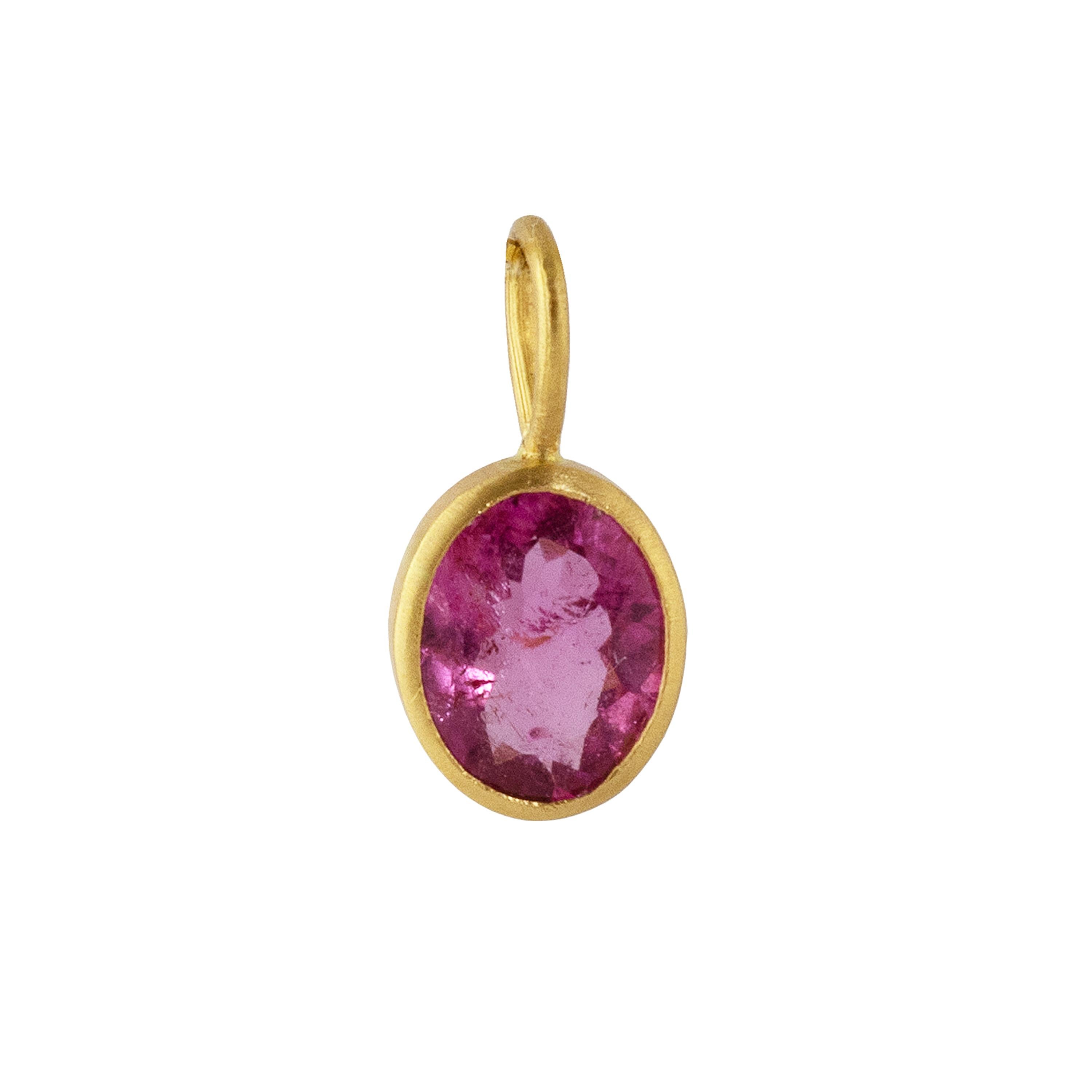 This deep Pink tourmaline Oval pendant is set in 22k gold and measures 14.5mm x 7.9mm.  Perfect worn alone or layered with other necklaces.

Discovered in the late 1600’s by Dutch traders off the West Coast of Italy, tourmalines are found in an