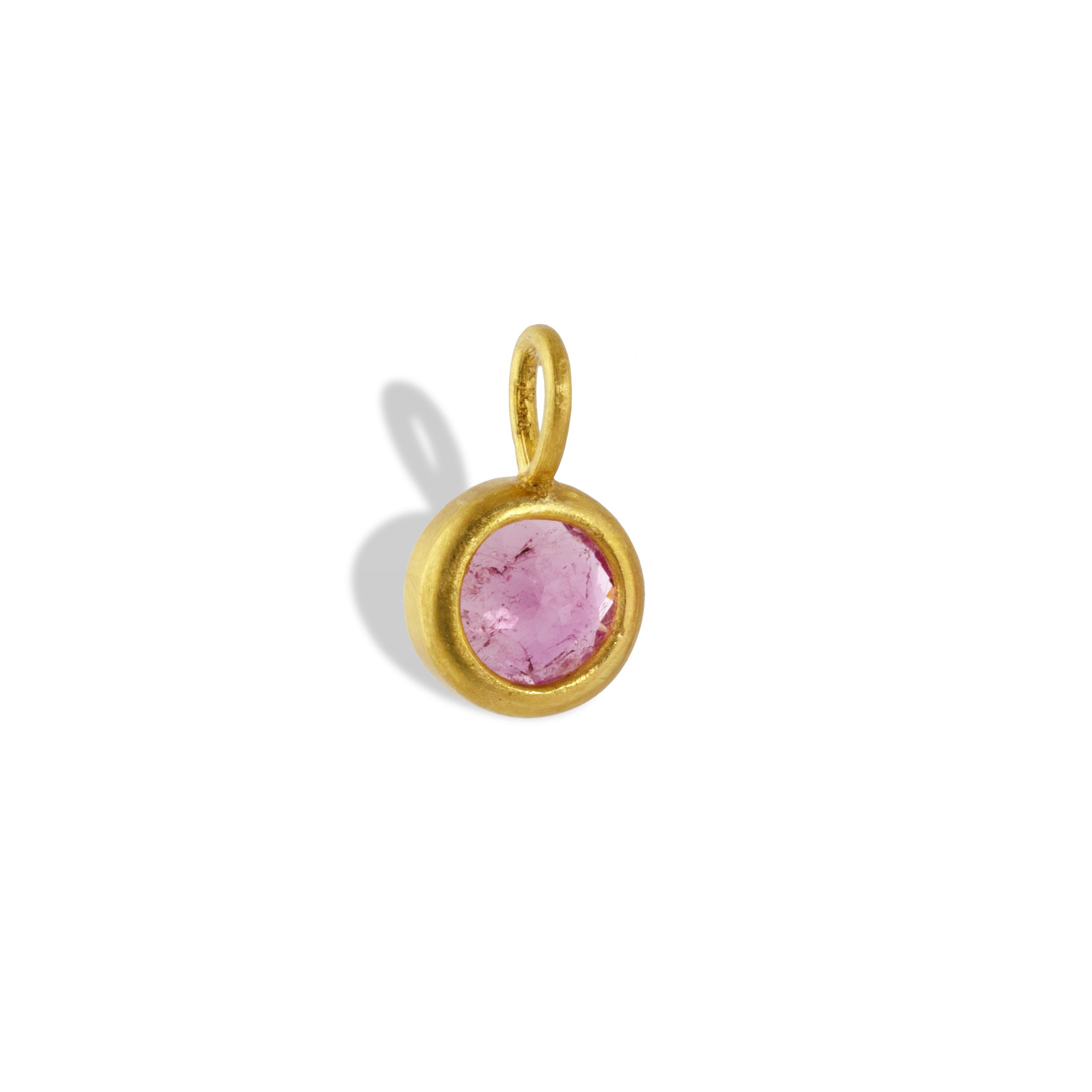 A delicate pink tourmaline is set in 22k yellow gold.  This delicate pendant is 12.44mm long x 7mm wide and 5mm deep. 

Pink tourmaline represents a love of humanity and humanitarianism. It is worn to promote sympathy towards others.  It is one of