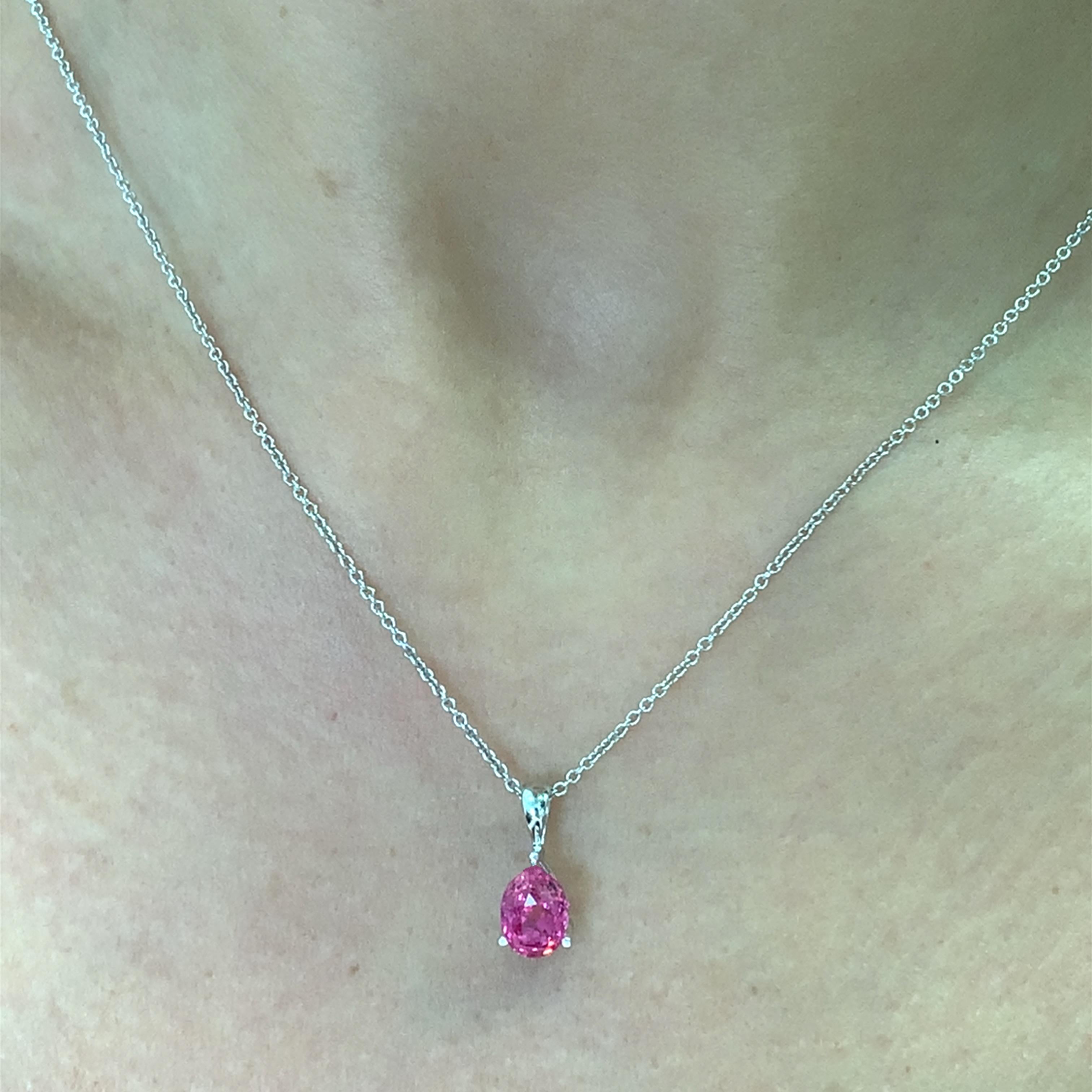 This stunning pink tourmaline oval shaped solitaire pendant necklace is the perfect accessory for any occasion. Crafted in 18k white gold with a delicate 18 inches chain, it features a vibrant oval cut pinkish vivid colour tourmaline that catches
