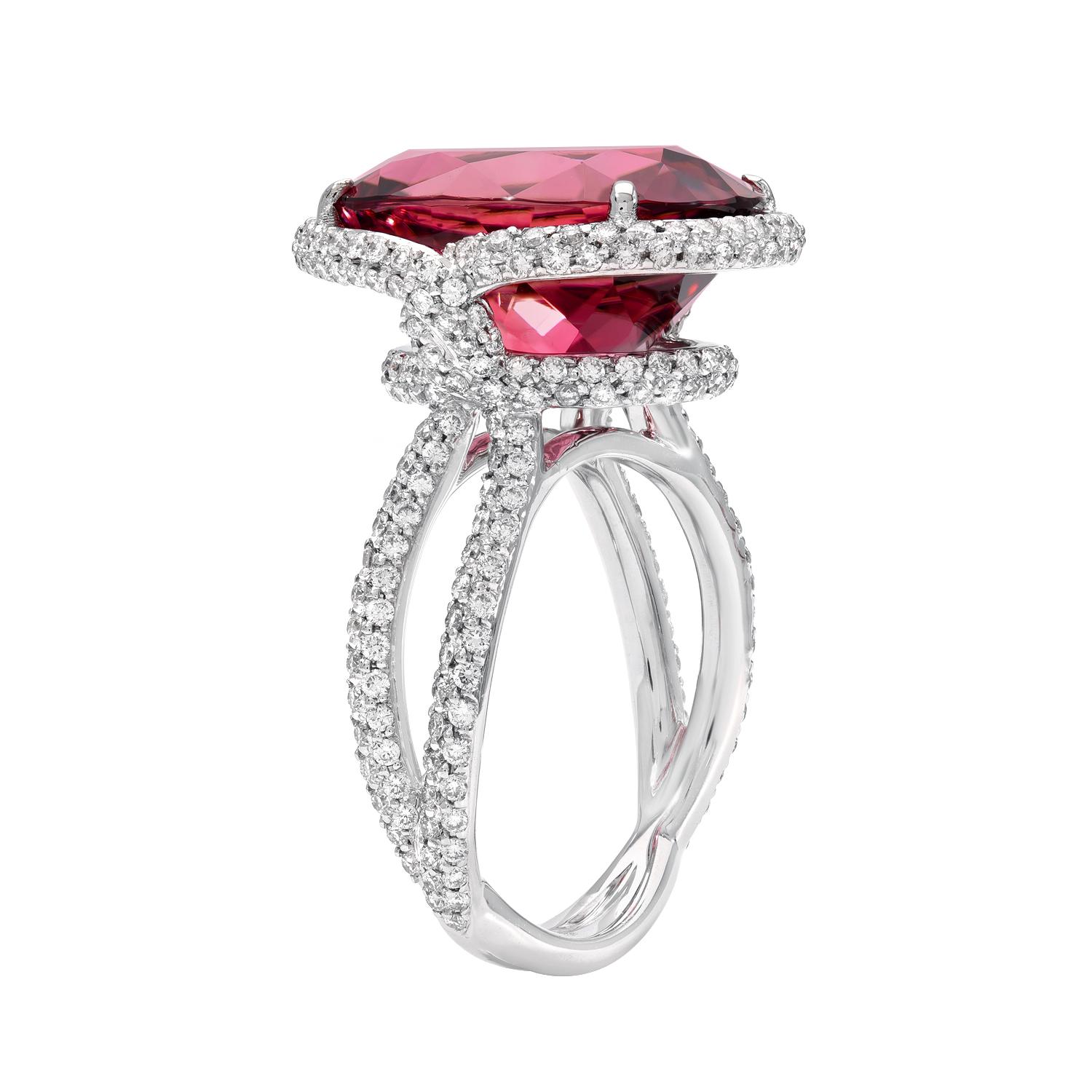 White gold diamond ring showcasing a spectacular 11.69 carat oval Rubellite Tourmaline, accented by a total of 1.16 carat round brilliant diamonds. 
Crafted in 18K white gold.
Size 6. Resizing is complementary upon request. 
Returns are accepted and