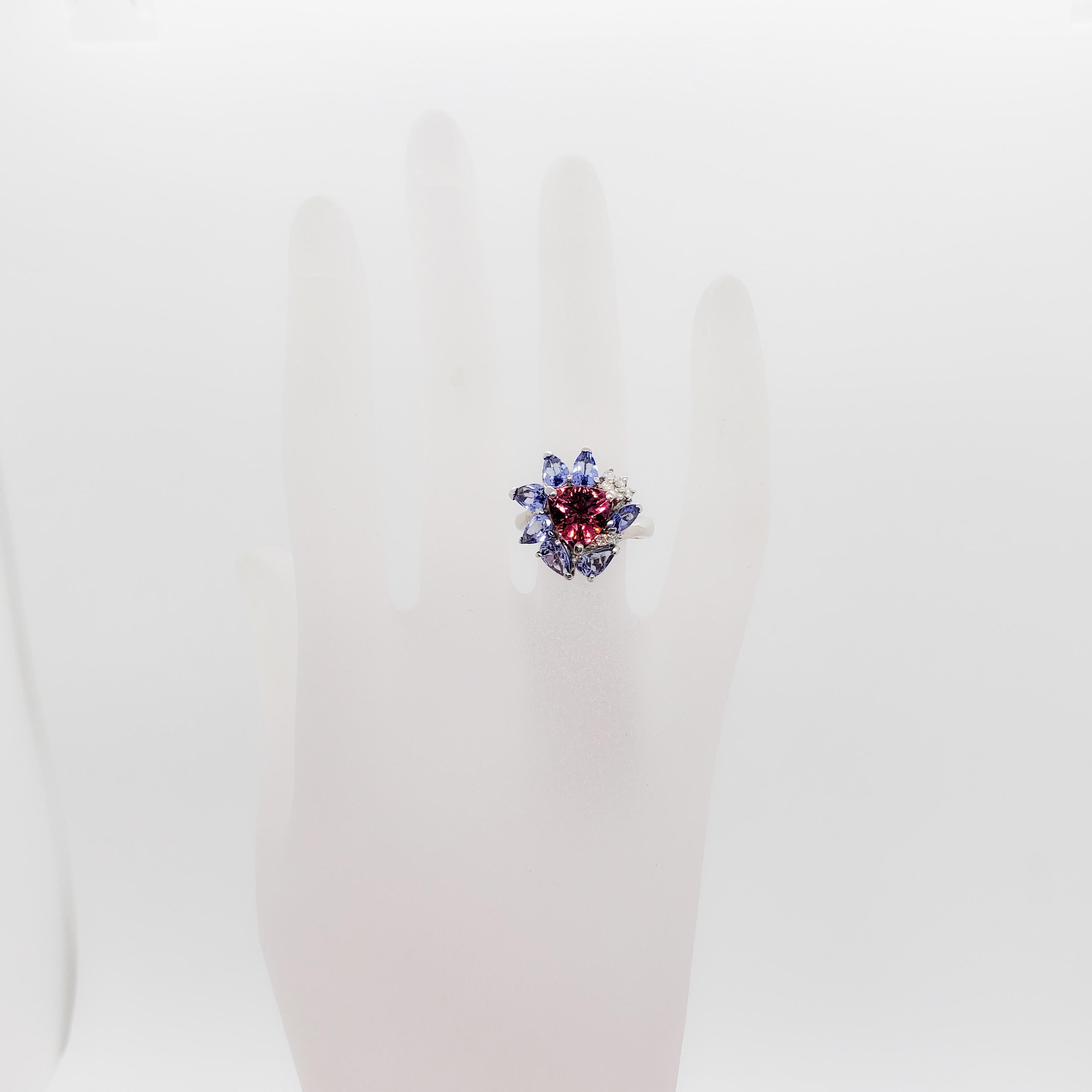 Beautiful colorful ring that showcases 2.05 ct. of pink tourmaline trillions, 2.30 ct. of tanzanite pear shapes and marquises, and 0.10 ct. of white diamond rounds.  Very unique design and combination of stones that make this ring fun and flirty. 