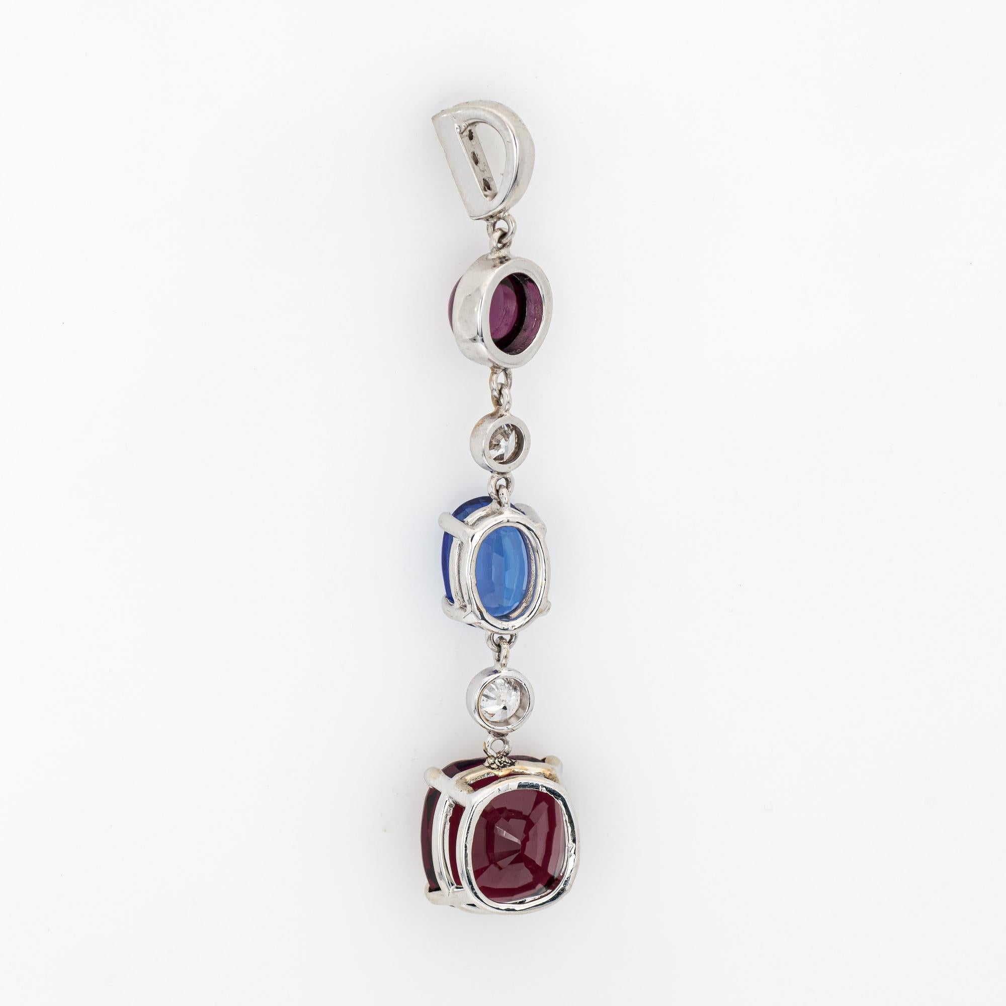 Finely detailed pink tourmaline, tanzanite and rhodolite garnet & diamond pendant crafted in 14k white gold.  

Round cabochon cut pink tourmaline is estimated at 1 carat, tanzanite is estimated at 1.50 carats and rhodolite garnet is estimated at