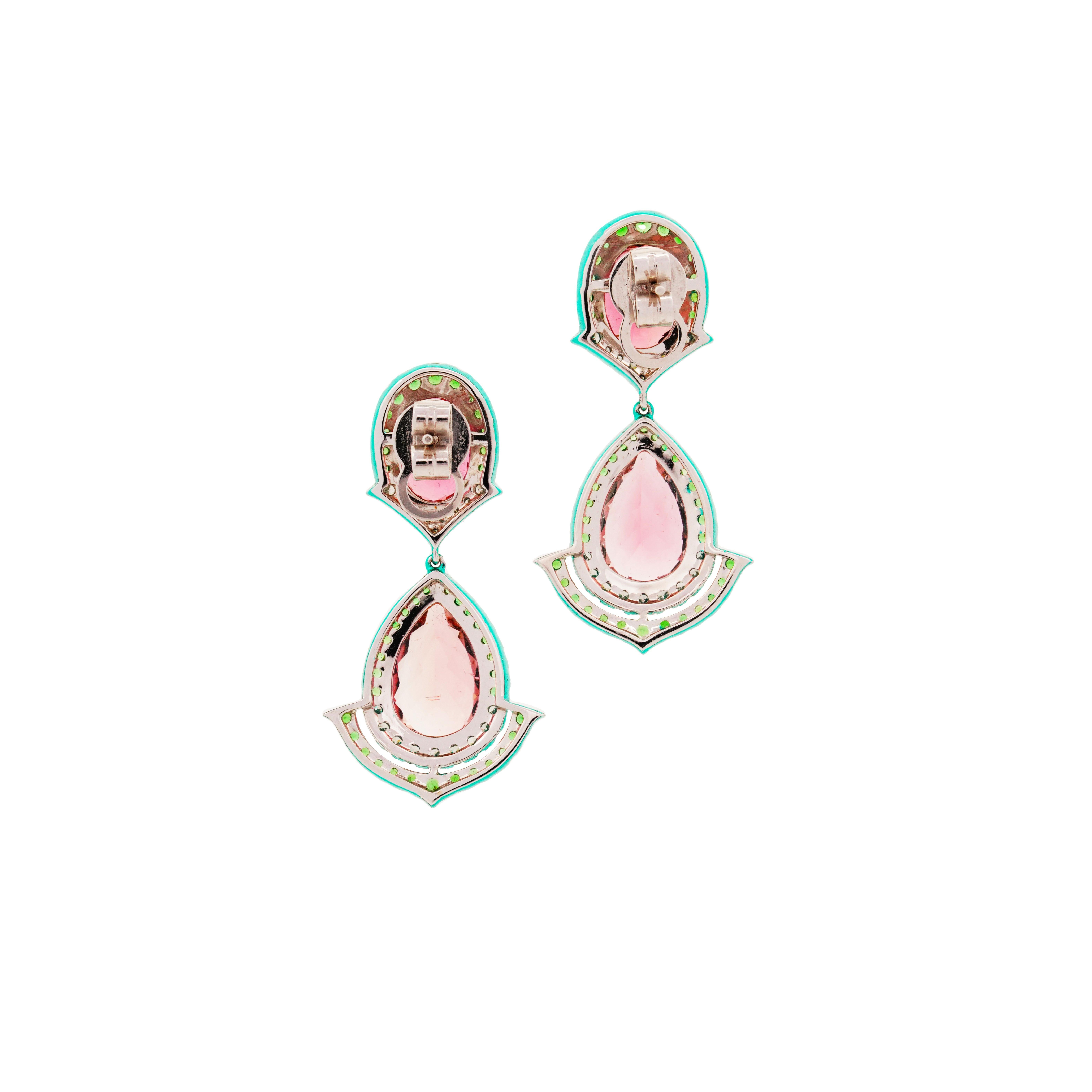 Behold the captivating beauty of these earrings, featuring two matching pairs of oval-cut and pear-shaped Pink Tourmalines. The simplicity of the design enhances the inherent allure of the gemstones, making these earrings a truly eye-catching