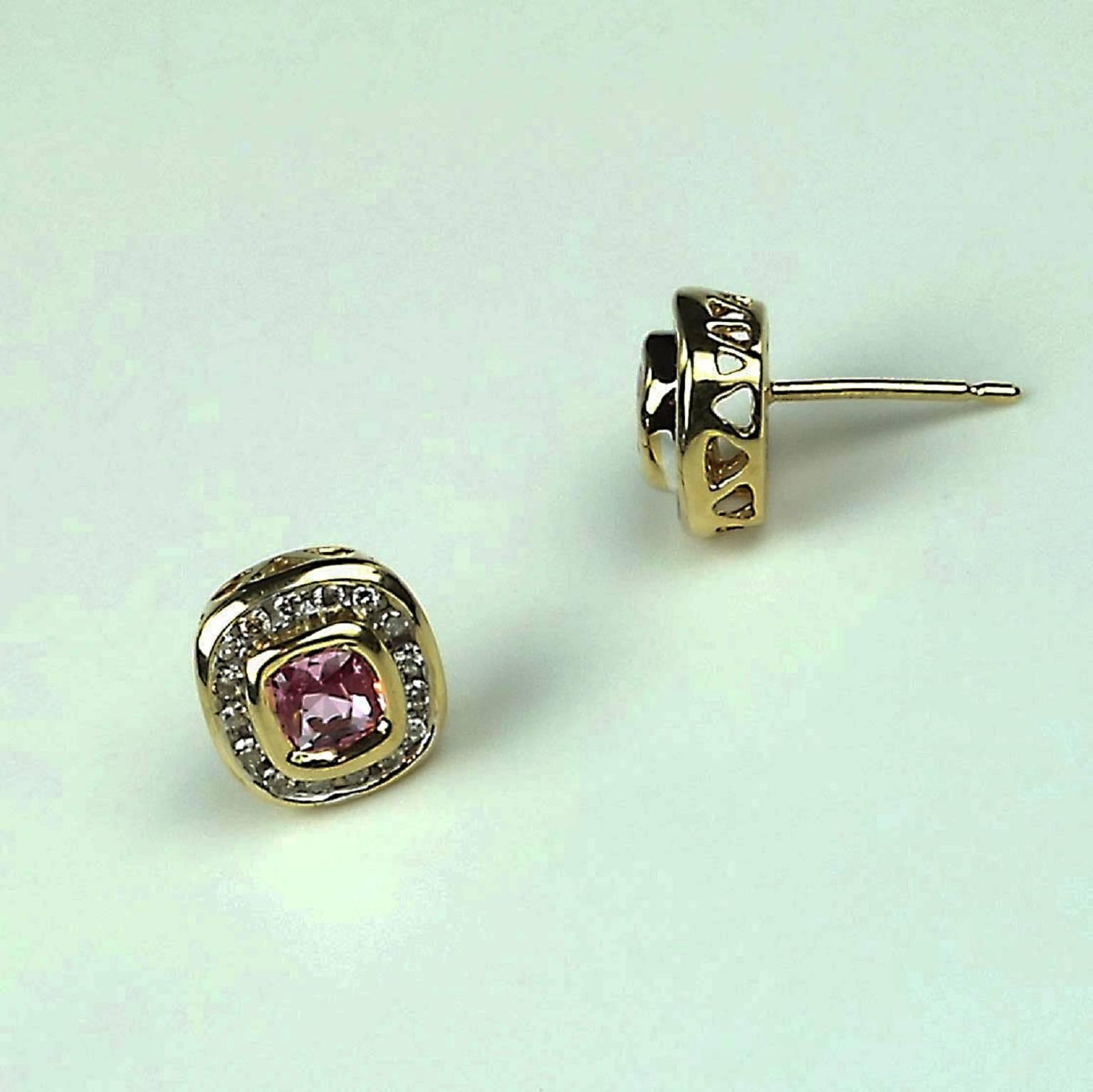 Delightful Pink Tourmalines bezel set in Yellow Gold, surrounded by channel set Diamonds in Stud Earrings.  The cushion cut, sparkling Pink Tourmalines are enhanced by the surrounding Diamonds and yellow gold.  The open work of the gold setting