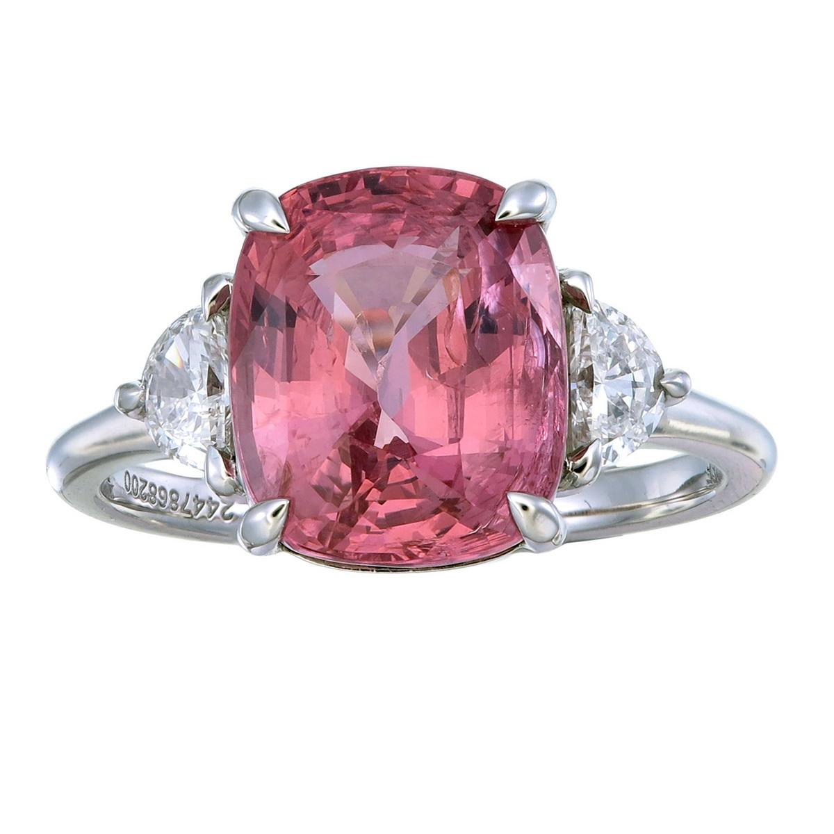 Orloff of Denmark;
With two VS1, G-H Half-Moon Diamonds on each side, this substantial 5.07 carat Pink Spinel is the focal-point of this Three-Stone engagement ring. At over 5 carats with a soft yet prominent brilliance parred with a soothing pink
