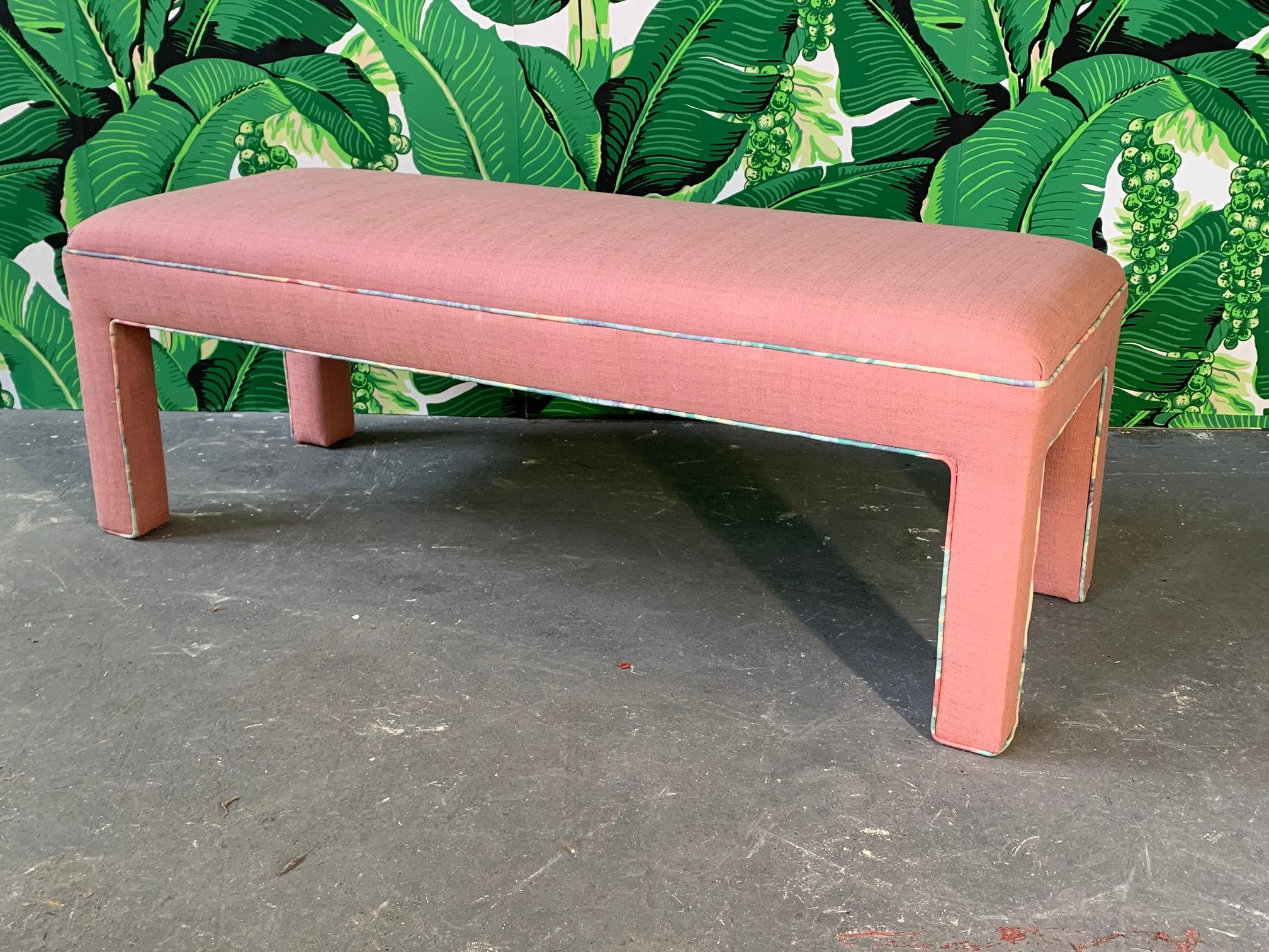 Upholstered bench or ottoman in true 1980s style. Pink with pastel tropical piping. Very good condition.
    