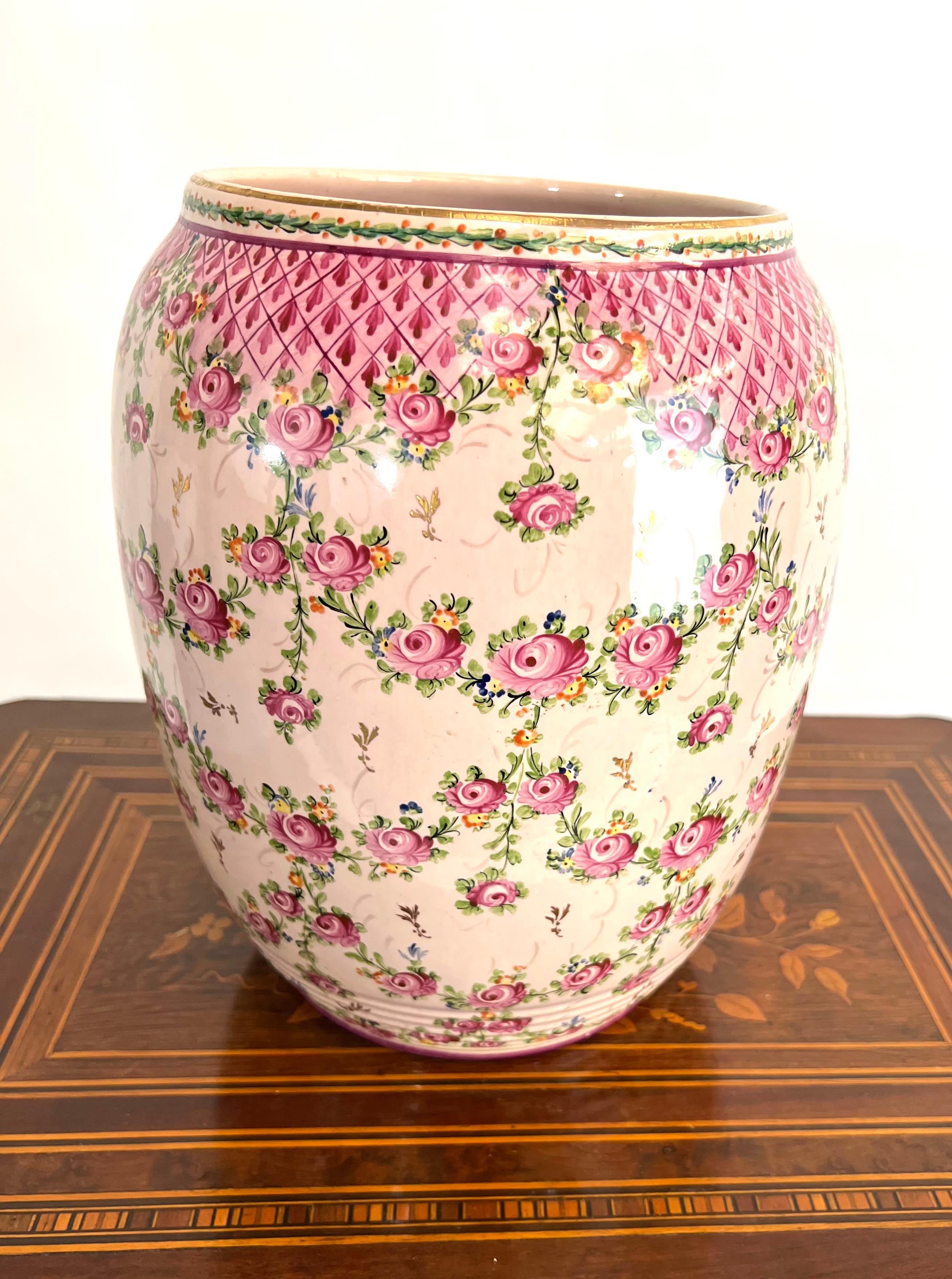 This superb Clamecy faience vase features a delightful decoration of intertwined roses and delicate lattice patterns. The vase is carefully signed underneath, adding an authentic touch and value to this piece. With its romantic and delicate