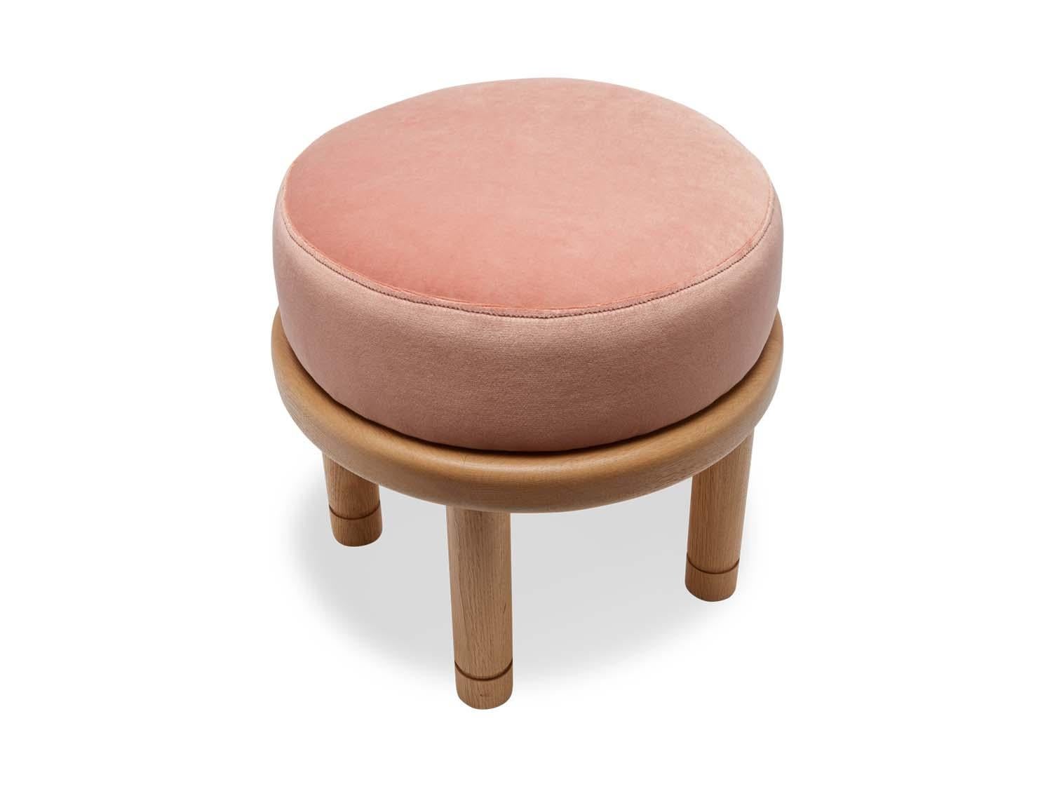 The Petite Moreno ottoman features a round solid wood base with four cylindrical legs and an upholstered top. Available in American walnut or white oak. Shown here in pink velvet and natural oak.

The Lawson-Fenning Collection is designed and