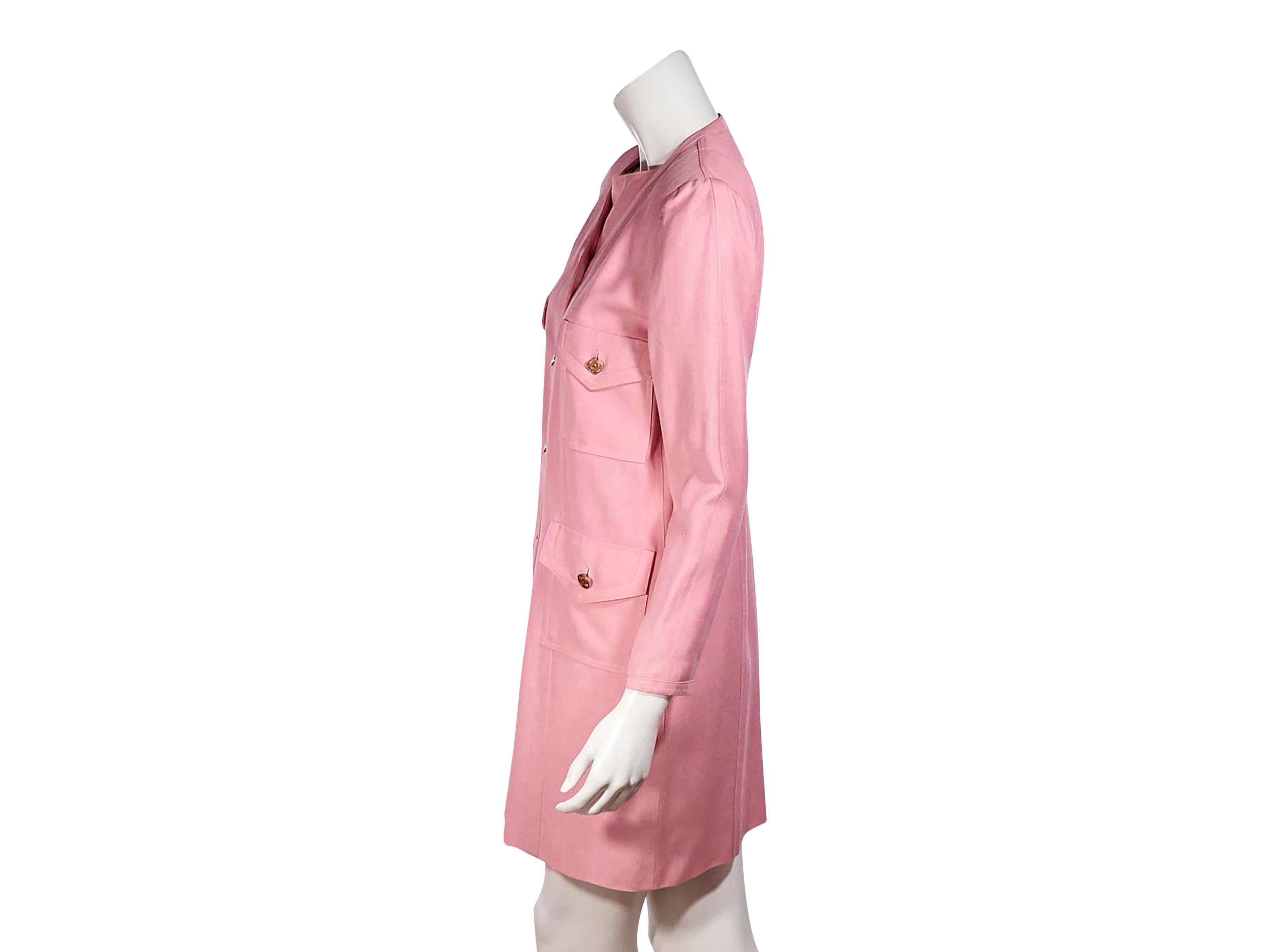 Product details: Vintage pink silk jacket and dress set by Chanel Boutique.  V-neck. Cropped long sleeves. Four pockets at front. Embossed logo gold-tone buttons. Button front closures. Matching sheath dress. Scoop-neck.  Sleeveless. Contrast detail