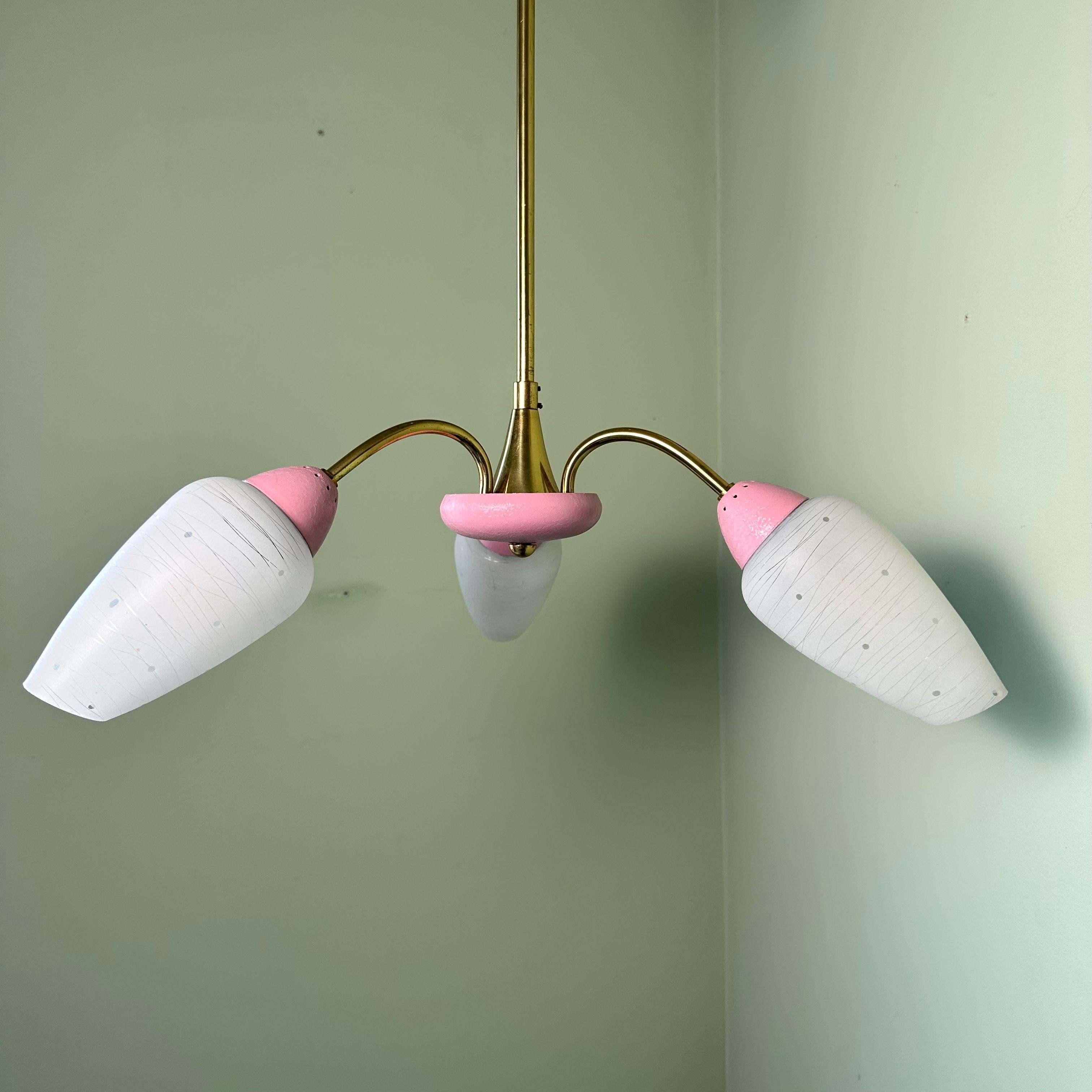 Vintage feminine and playful Italian style midcentury 3 arm Sputnik chandelier in Brass with bubblegum pink painted accents. The 3 curved brass arms create a downlight effect with cone shaped frosted glass diffuser shades. Etched into the frosting