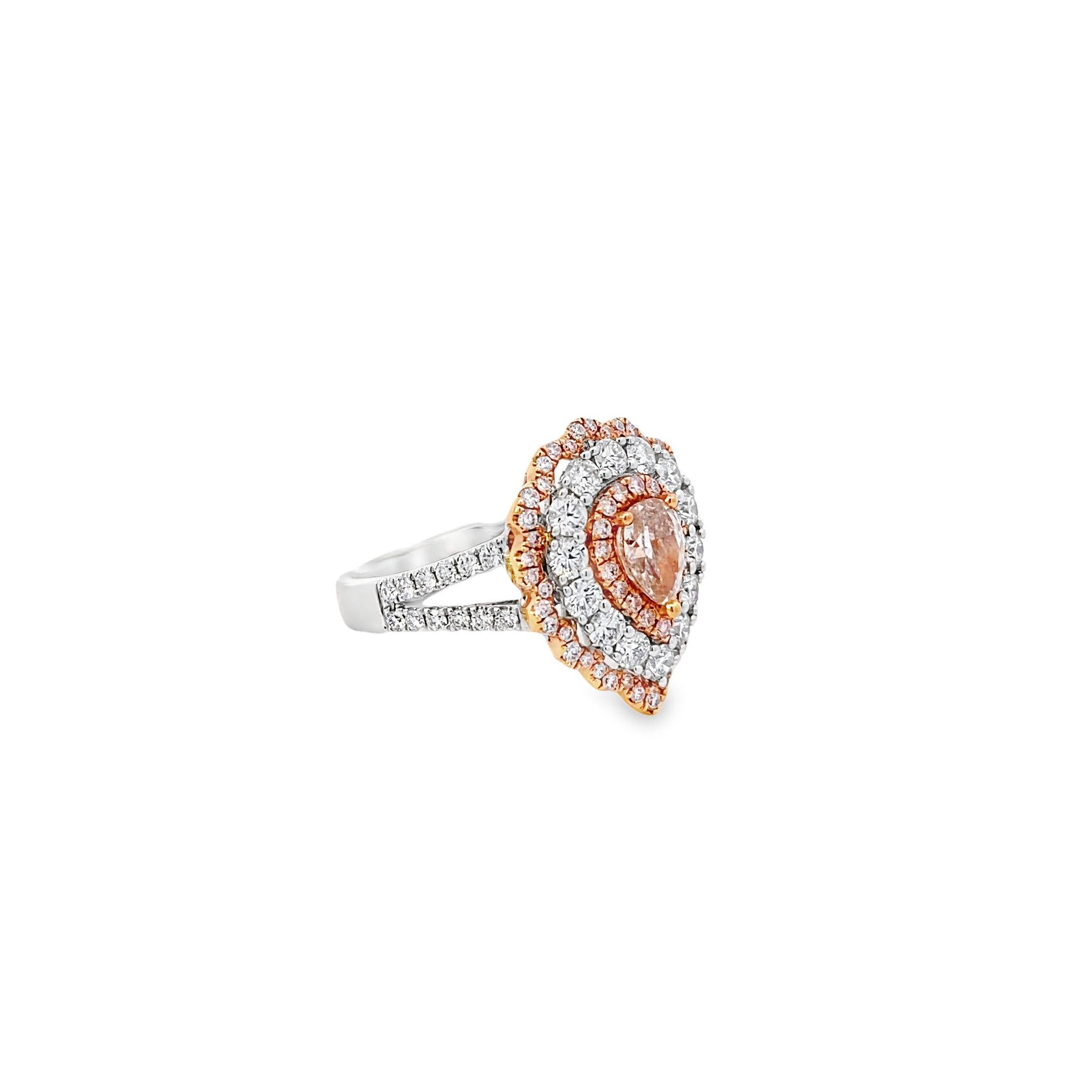 This stunning ring, crafted in 18k white and rose gold, features a 0.71 carat pink pear-shaped diamond at its center. The centerpiece is surrounded by a triple halo of diamonds, with 1.05 carats of white round diamonds and 0.36 carats of pink round