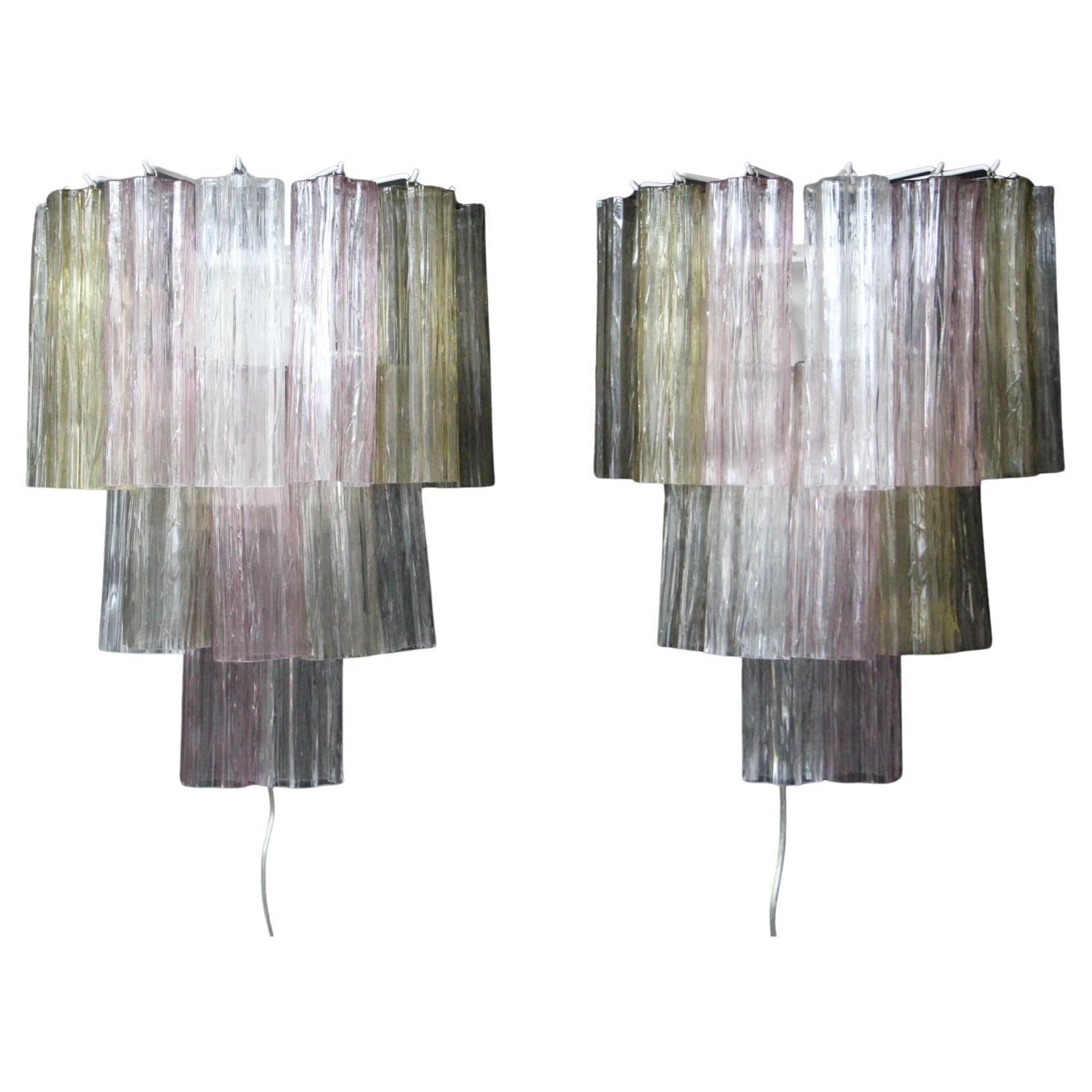 This Venini's style Murano glass pair of sconces is magnificent. Its beautiful and very soft colors are very unique . Indeed , it features pink, clear, yellow and smoked color glass tubes ending in flower shapes . From underneath, it looks like a