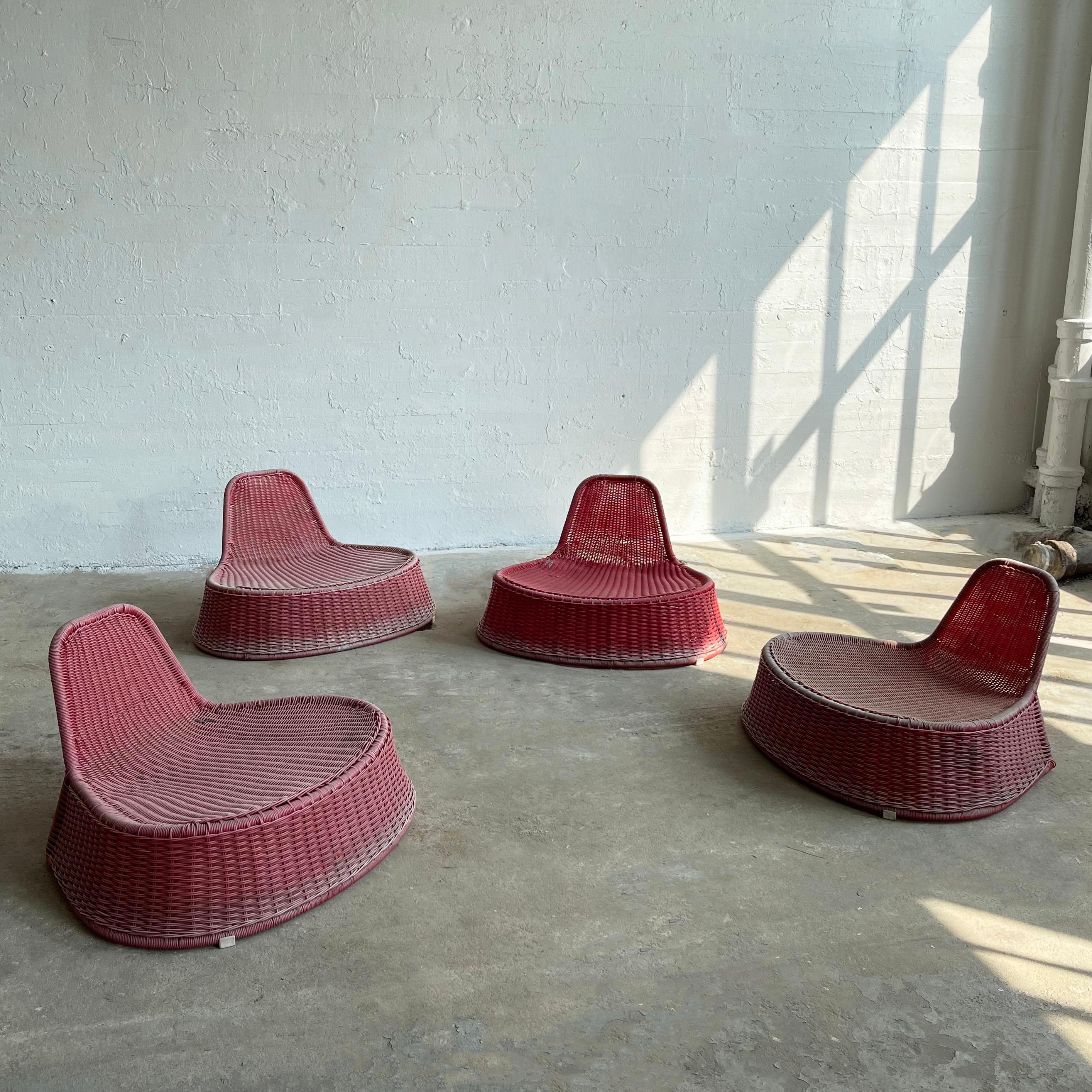 Set of four, colorful, modern, outdoor lounge chairs by Dutch designer Monika Mulder for Ikea circa 1990's are fuild, raspberry pink rattan, woven plastic, organic forms that command an interesting and playful presence both indoor and outdoor. The