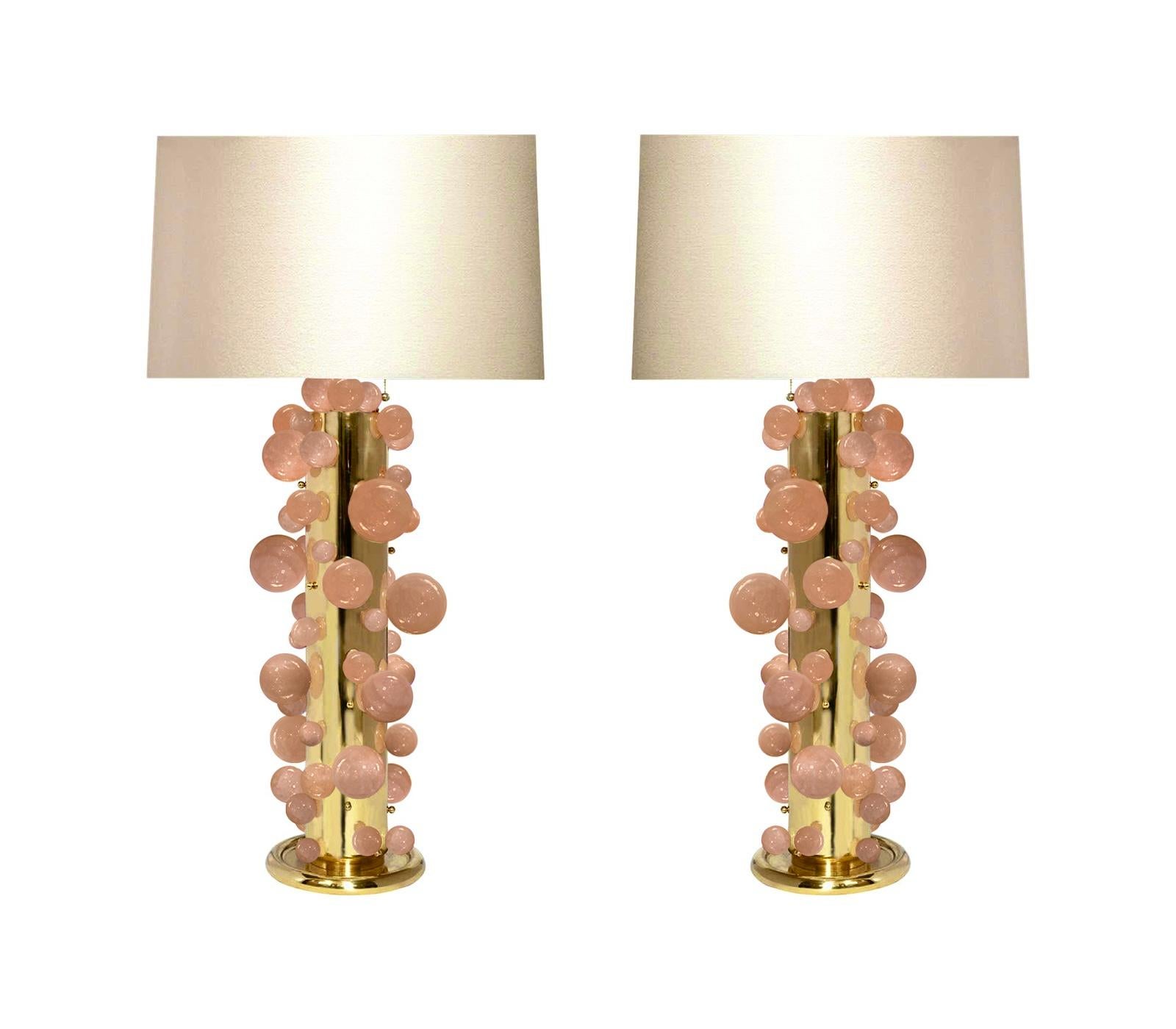 A tall pair of pink rock crystal quartz bubble lamps with polished brass frames. Created by Phoenix Gallery, NYC. Each lamp installed two sockets. To the top of the rock crystal 25.75