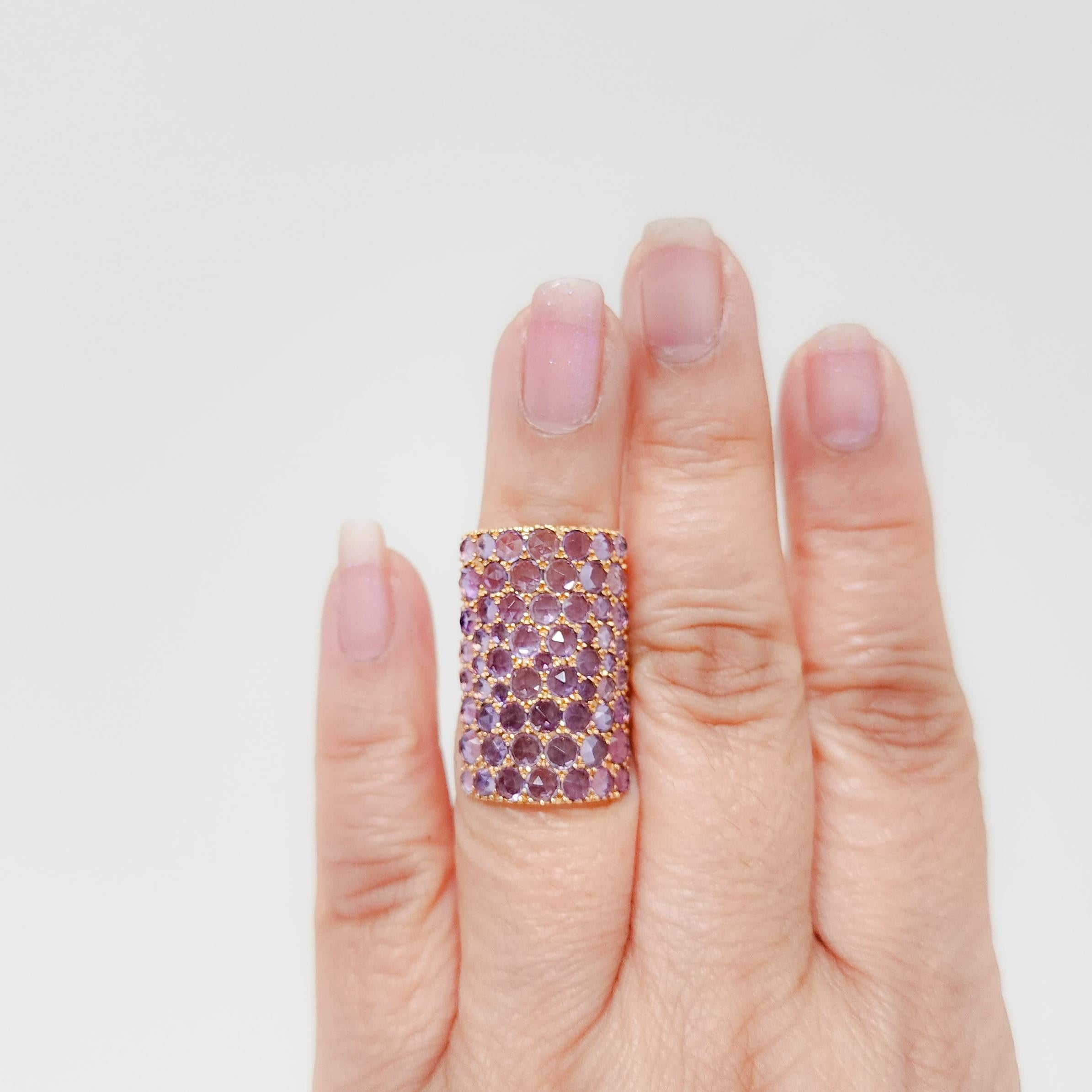 Beautiful ring featuring 3.50 cts of unique pinkish purple amethyst rounds in a handmade 18k rose gold mounting.  This design elongates the fingers.  There is a designer stamp, but it is unknown.  Looks like an 