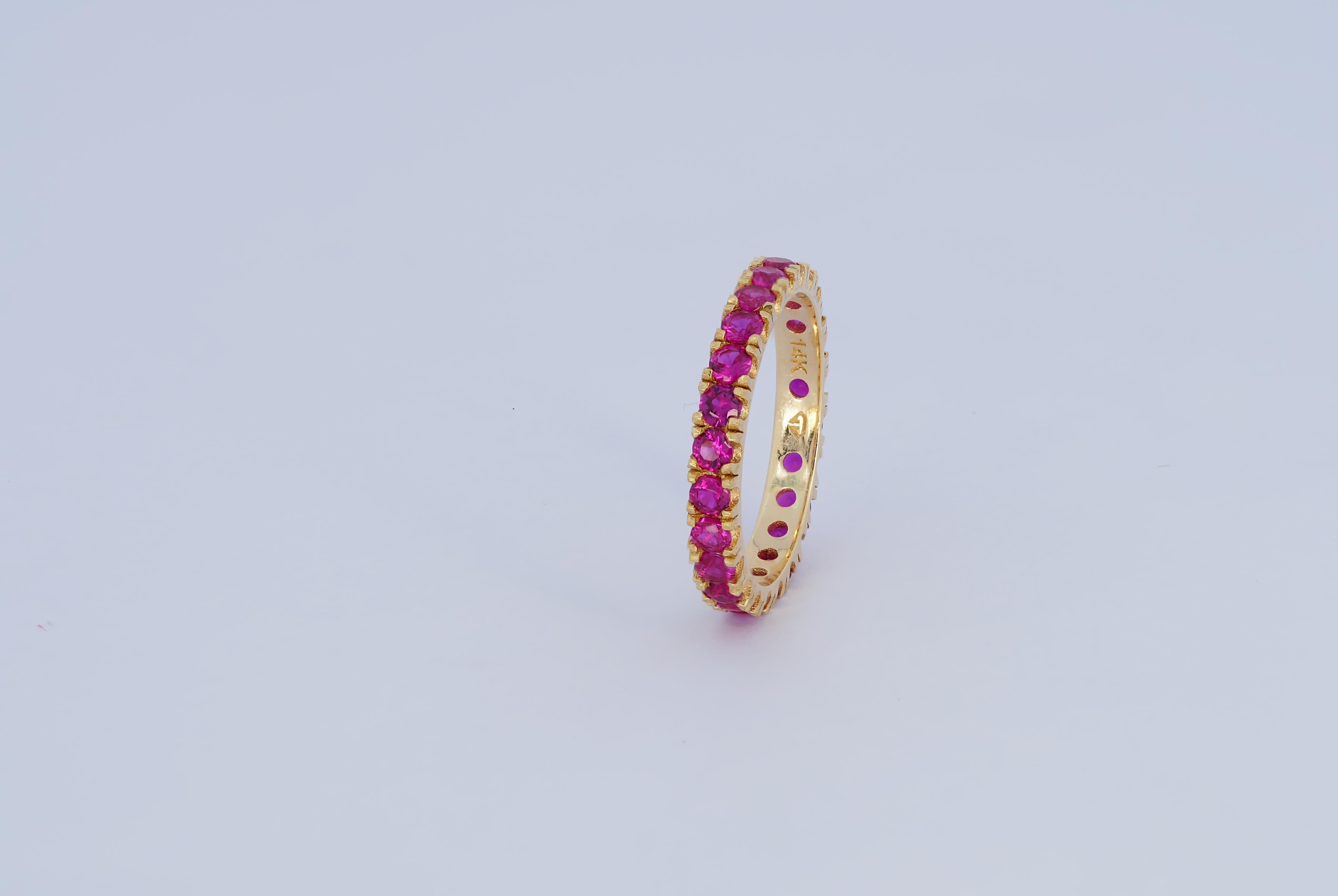 For Sale:  Pinkish red gemstone 14k gold eternity ring band. 12