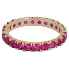 Pinkish red gemstone 14k gold eternity ring band