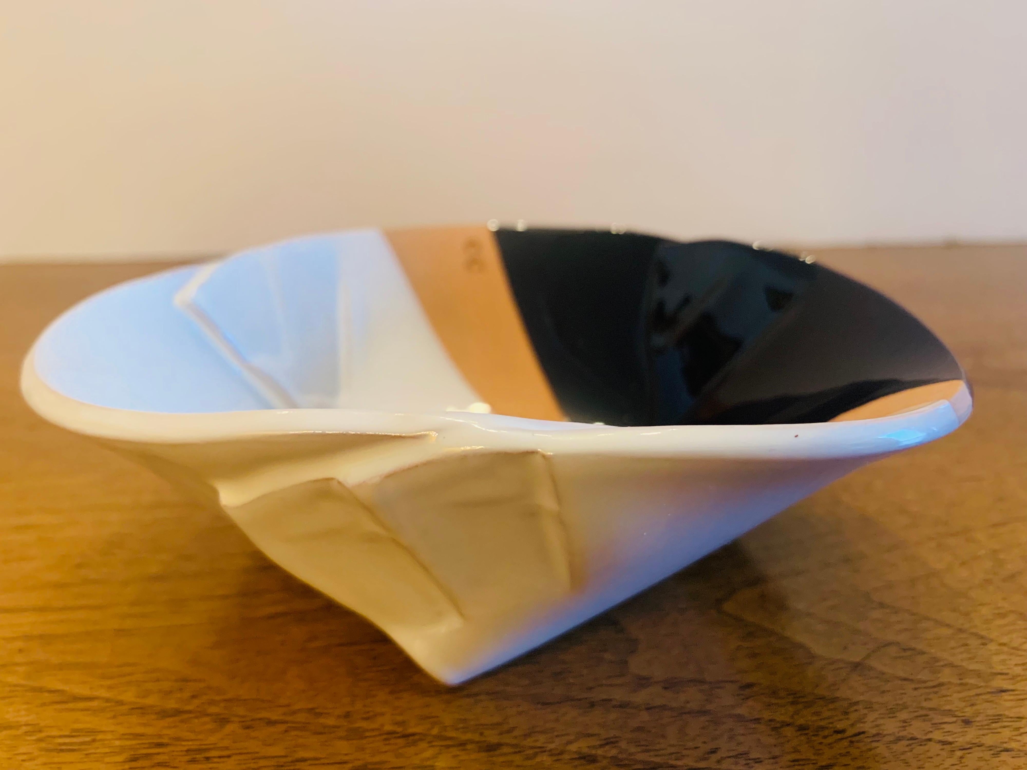 A great Italian Post Modern art pottery bowl by noted artist , Pino Castagna . Signed.
Biography:

Pino Castagna was born in Castelgomberto, Italy, in 1932, and studied in the schools of fine arts of Verona and Venice. Together with Scottish