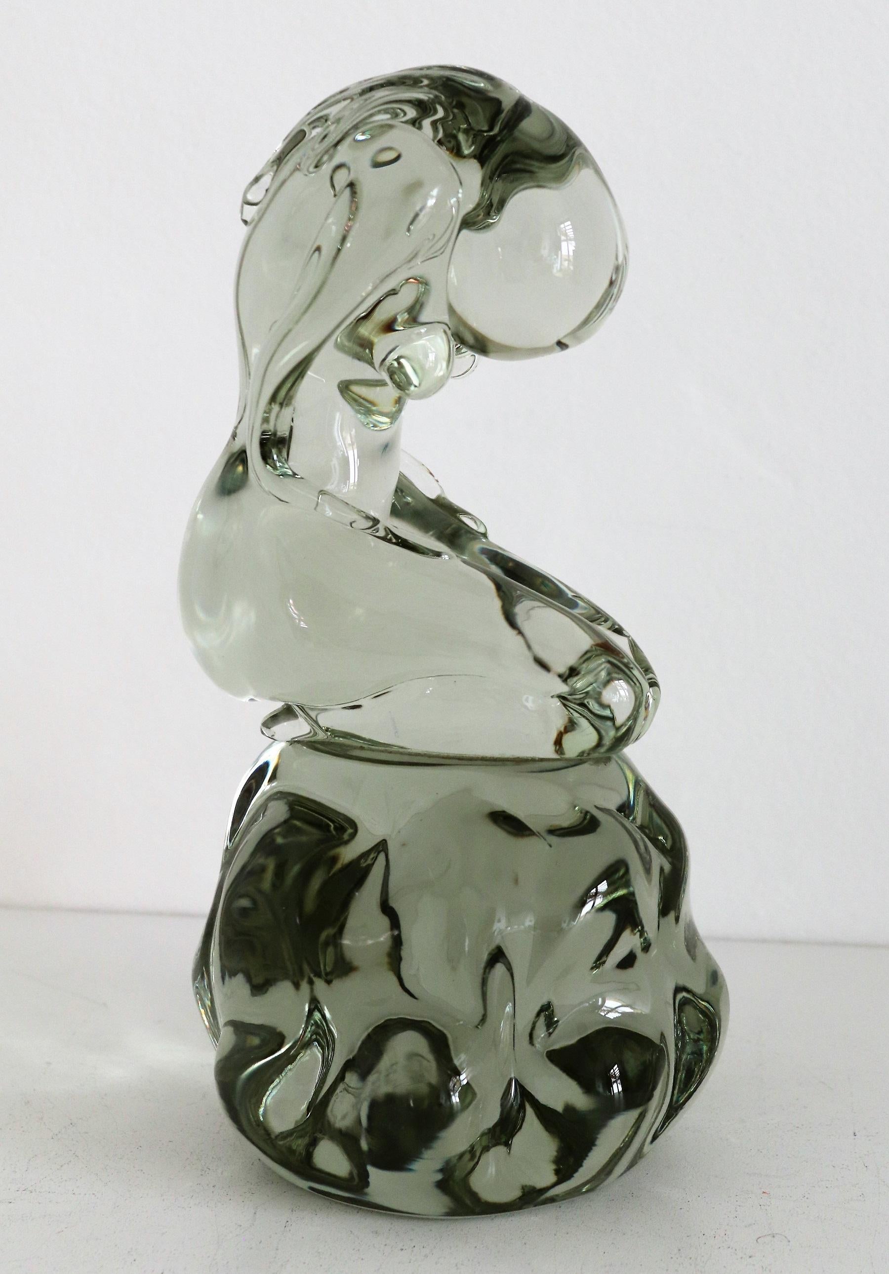 Beautiful glass sculpture made by Italian Murano Glass Master Pino Signoretto during the 1980s.
The sculpture shows a woman with long hair, kneeling, with her head bowed. Her arms are resting on her legs.
The sculpture is signed with Pino Signoretto