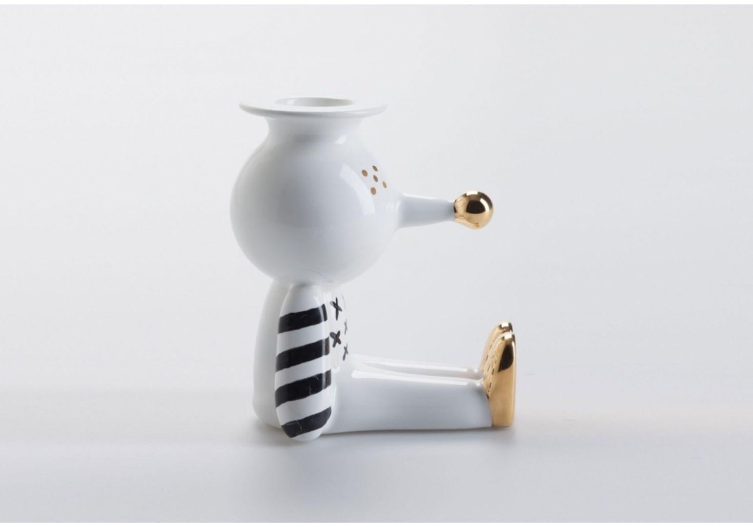 Pinocchietto designed by Jaime Hayon for Bosa is a candle holder in white ceramic with handmade decoration in glossy black and gold, that conjures up the image of the little puppet. Pinocchietto is an ironic ornament for the home and an amusing