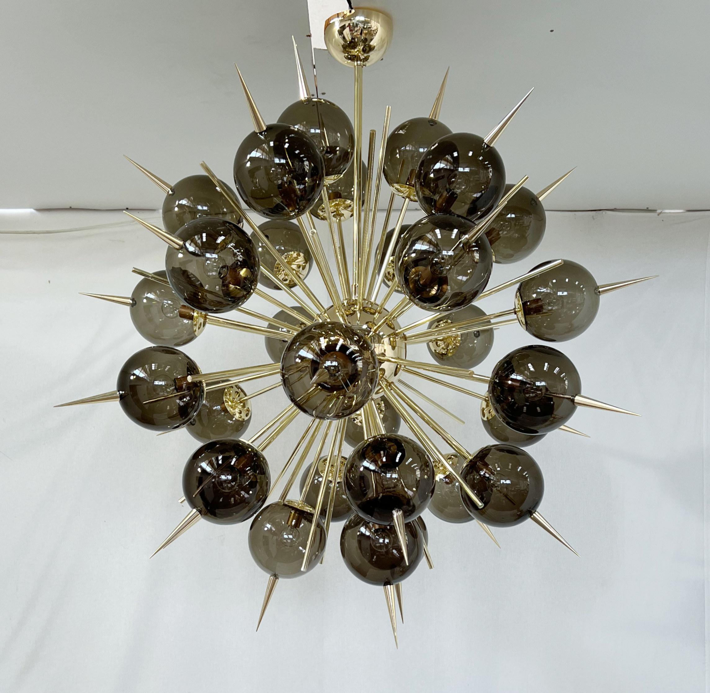 Italian Sputnik chandelier with 30 Murano glass globes and solid brass spikes mounted on brass frame / Designed by Fabio Bergomi for Fabio Ltd / Made in Italy
30 lights / E12 or E14 type / max 40W each
Measures: Diameter 47 inches / Height 54 inches