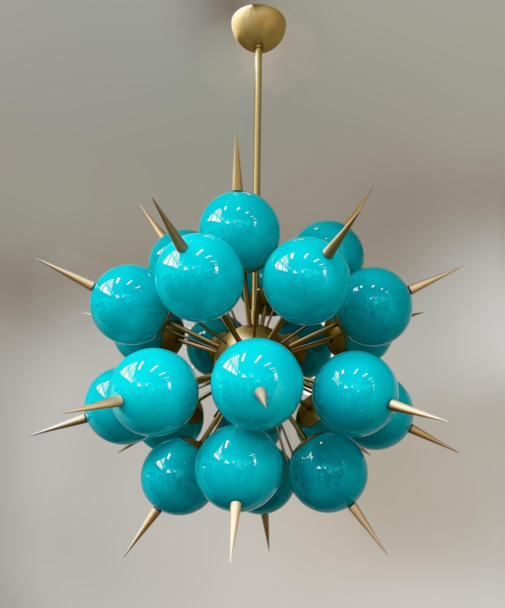 Italian sputnik chandelier with 24 Tiffany blue Murano glass globes and solid brass spikes mounted on brass frame / Designed by Fabio Bergomi for Fabio Ltd / Made in Italy
18 lights / E12 or E14 type / max 40W each
Measures: Diameter 38 inches,