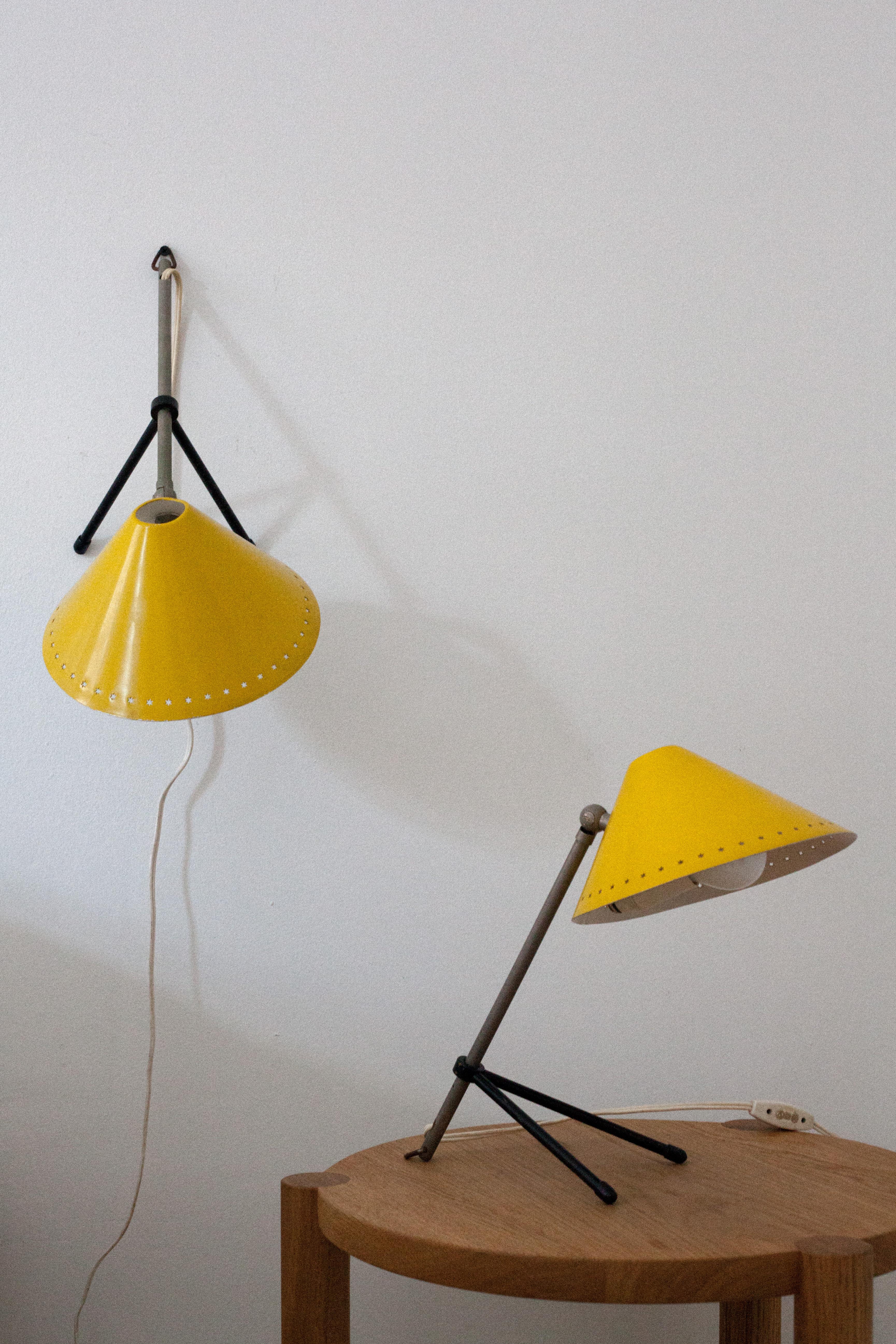 Bright yellow enamel Pinocchio lamp. Can be oriented as a table lamp or hung as a wall sconce. The lamp adjust in many directions. 

Euro wiring with a euro plug.