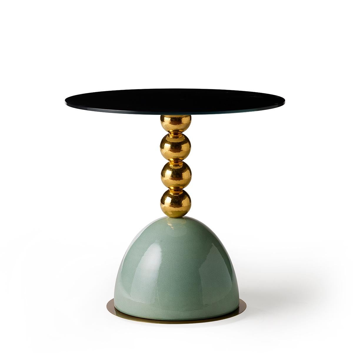 Pins Round Side Table with Spheres by Marioni
Dimensions: D 65 x H 65 cm. 
Materials: Brass details, 4 spheres and glazed ceramic base. Back painted glass top.
Product code: 02928

Pins round side table in brass with back-painted glass top and