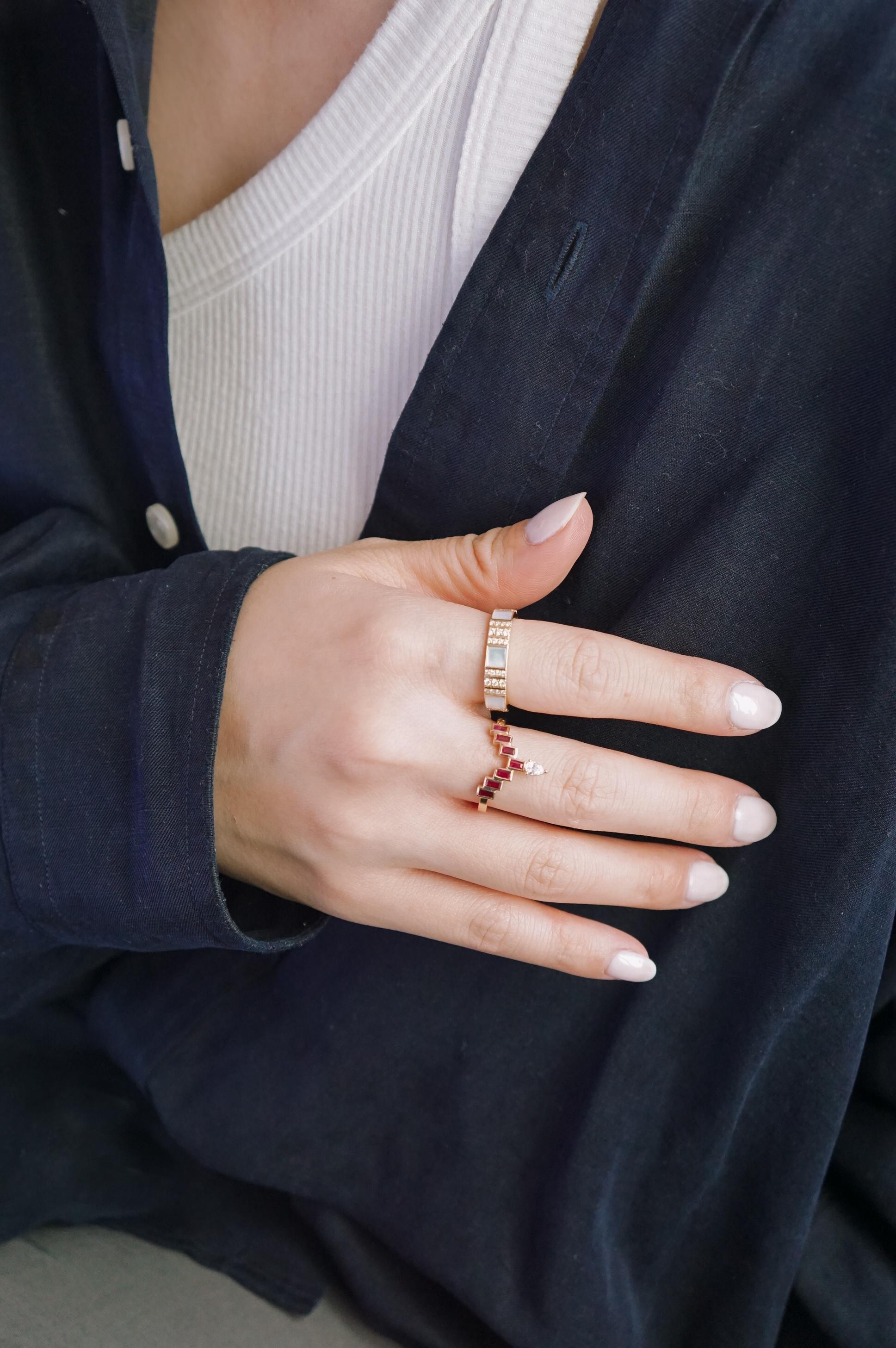 Highly polished 14k yellow gold with hand-set Brilliant Cut diamonds set in a pinstripe pattern define this bold and glamorous ring. With its bold and sturdy feel, this collection symbolizes strength and power. This stackable ring looks great worn