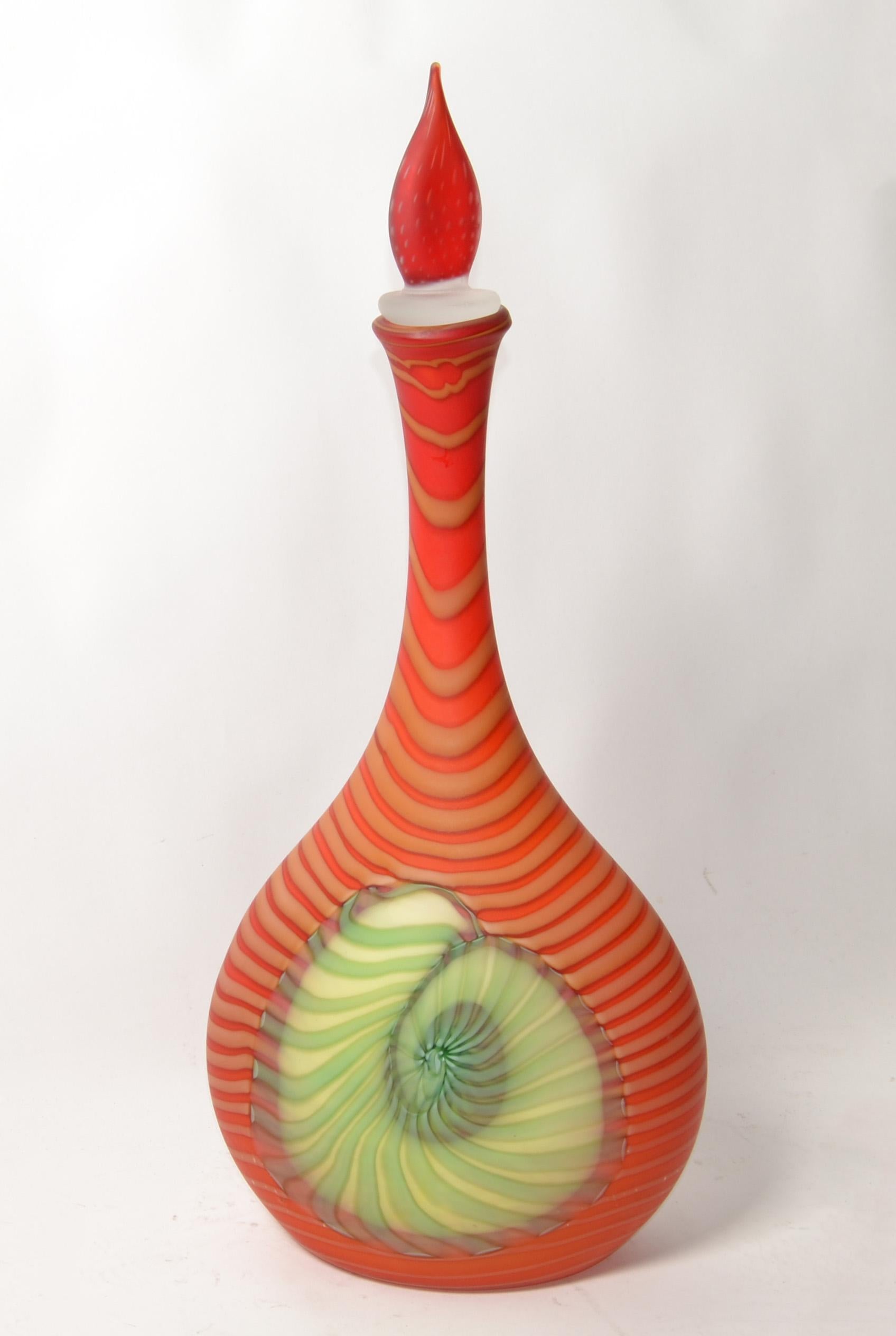 Engraved Giuliano Pinzan stunning and rare design Murano Art Glass hand blown red, orange, peach, green and blue with nautical Seashell Motives, genie bottle decanter. 
The piece is lined inside with white Glass and the outside has gorgeous swirl