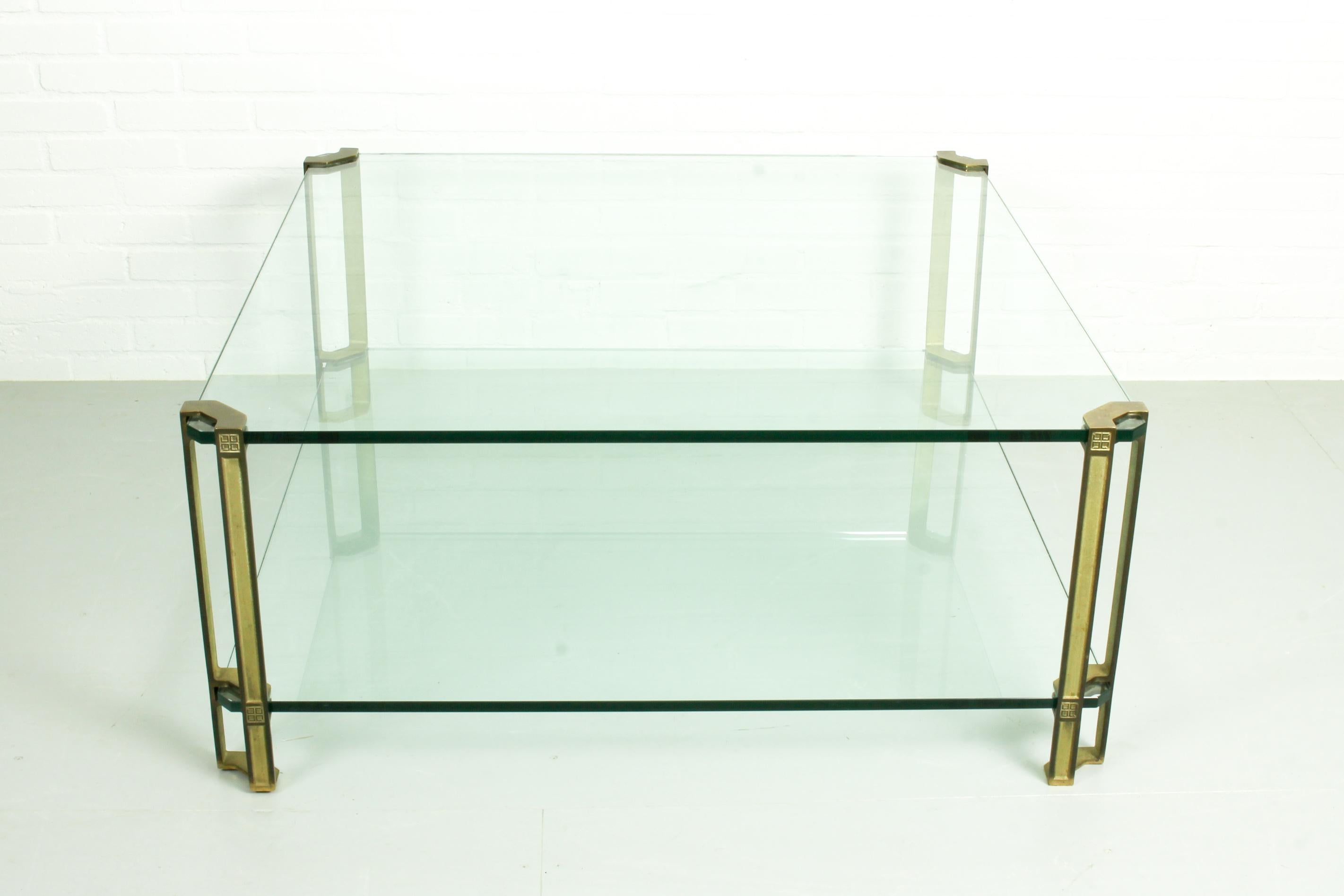 Vintage coffee table designed and fabricated by Peter Ghyczy, The Netherlands 1970s. Large square T24D model from the Pioneer serie. Solid brass with hardened glass. he glass has a thickness of 15 mm The table T24D has two levels. Table is in a very