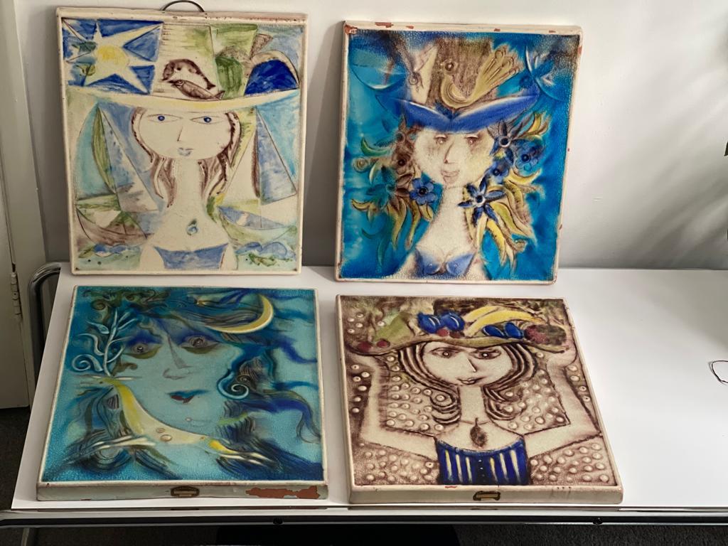 A fantastic set of four 20th-century vintage decorative wall ceramic plaques handcrafted by Danish artist Piotr Baro in between the 1940s and 1950s. These colored designs are much rarer than the black and white pieces. 

30cm x 34.5 cm x 2cm
Each
