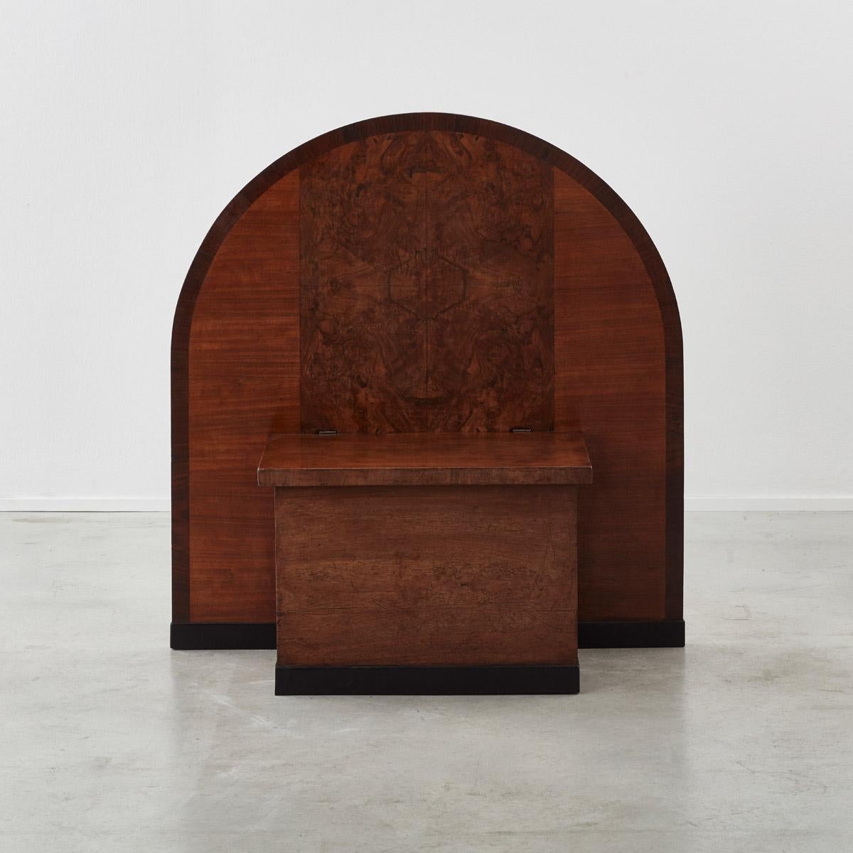 A striking entrance bench with storage box and tall arched back. With beautiful, burred walnut veneer panels to the back. Made by the producer Piozzi Provini in the town of Cesano Maderno in Northern Italy in early to mid-20th century. An unusual