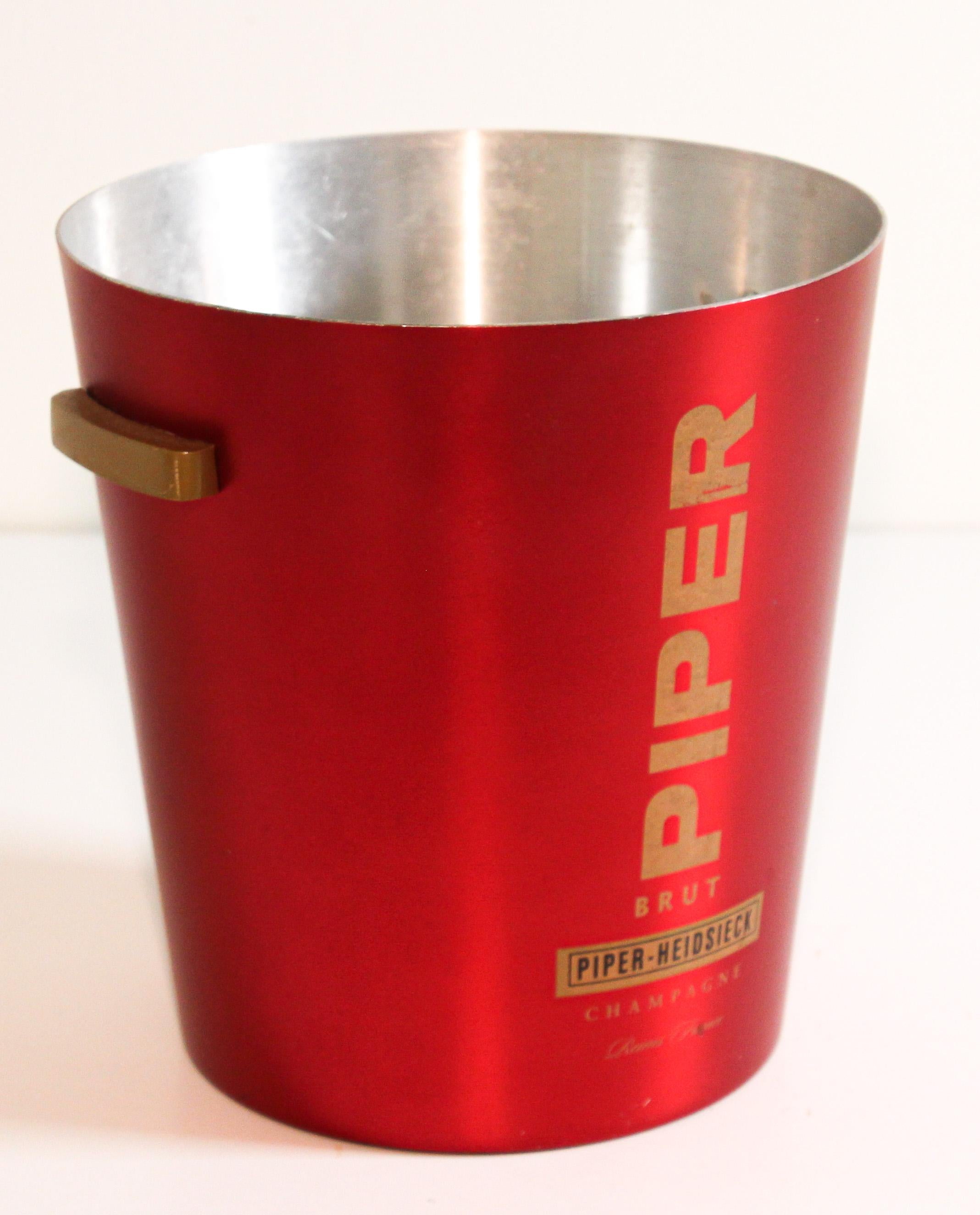 An aluminum 1970s champagne red ice bucket manufactured in France for the Piper-Heidsieck champagne house founded by Florens-Louis Heidsieck in 1785.
Champagne bucket cooler. Great color combination in red and aluminum, hard to find.
There is a