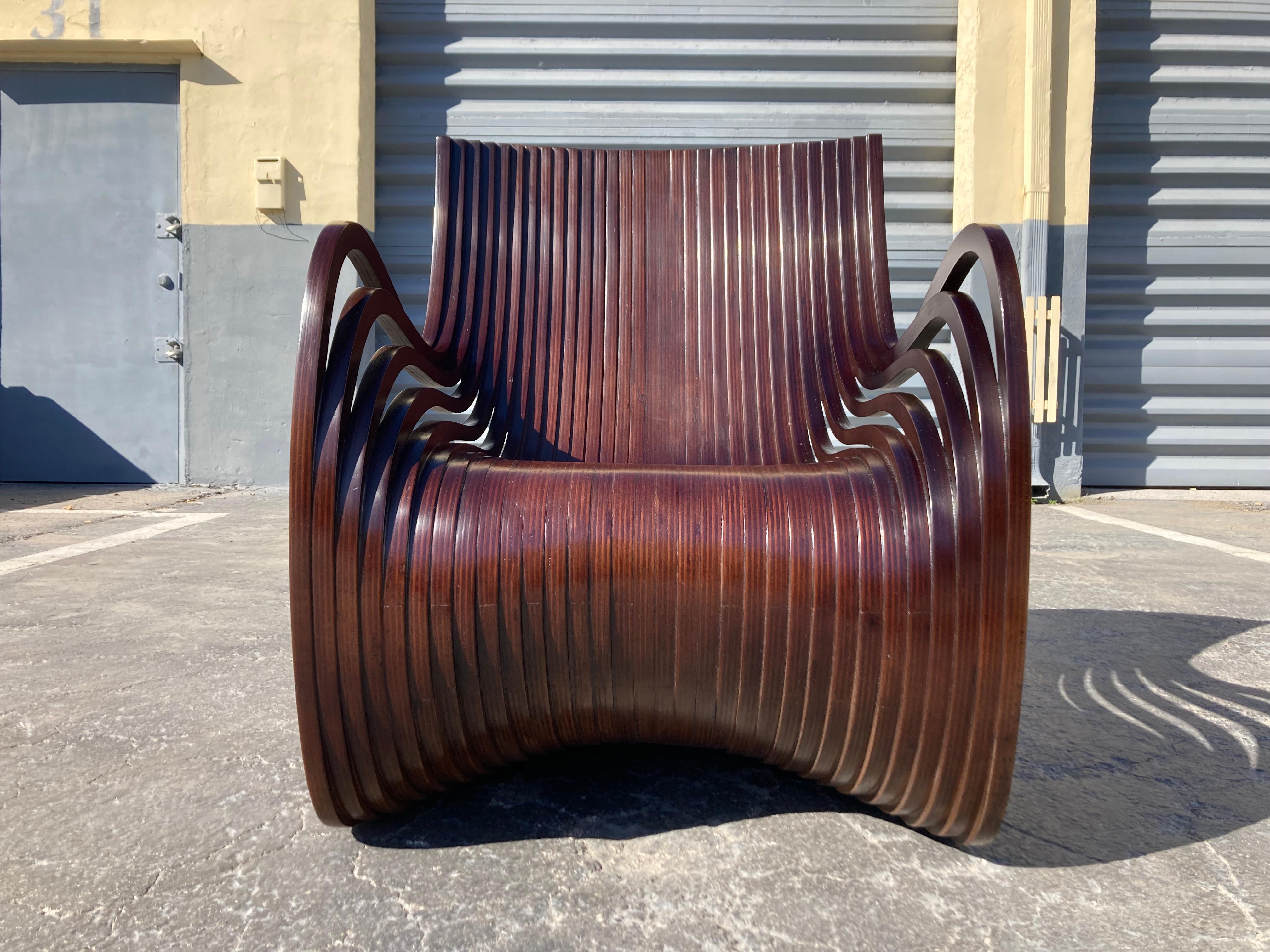 Pipo Lounge chair by Piegatto in dark walnut finish.