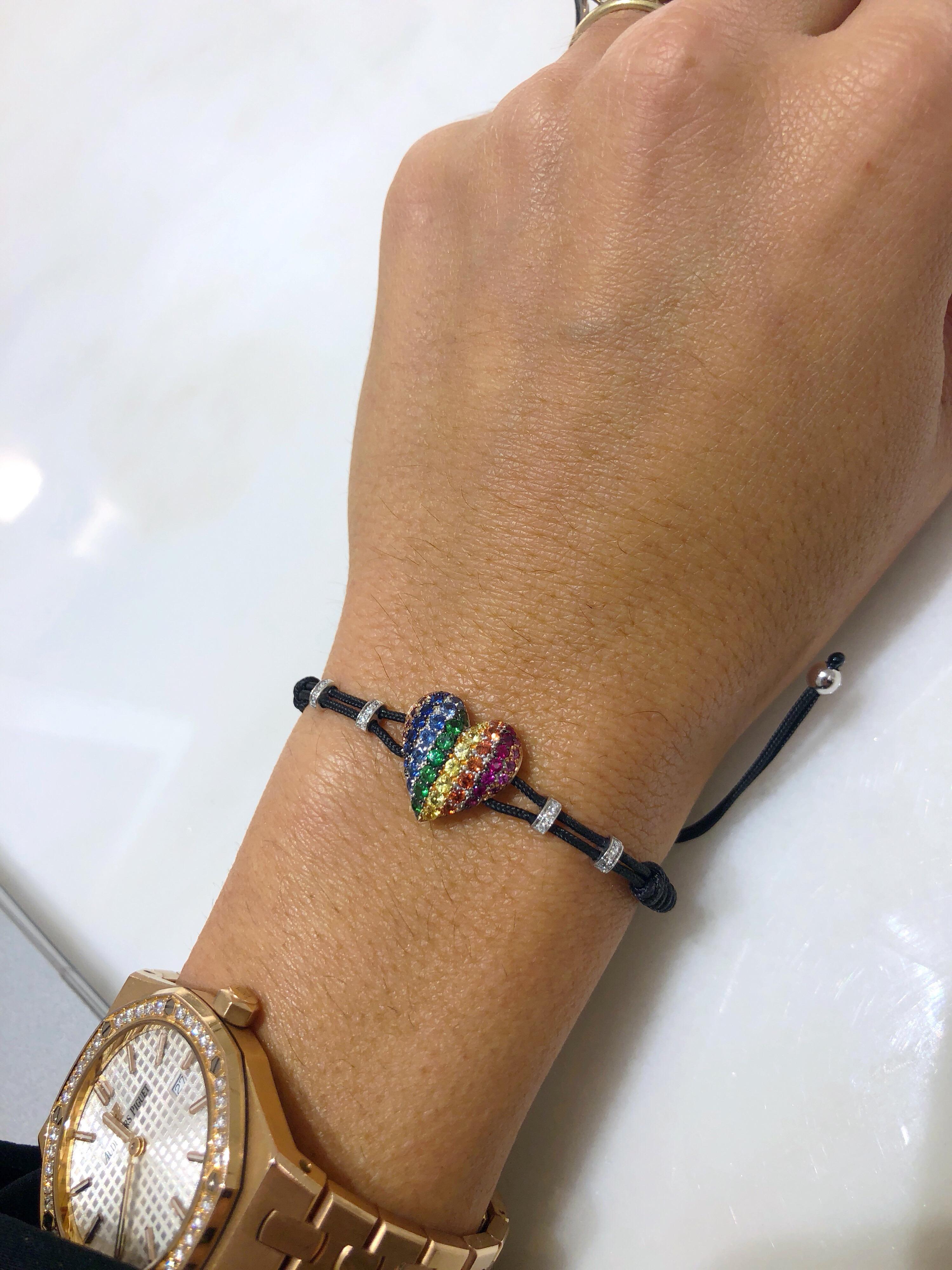 This Pippo Perez Rainbow Heart Bracelet is set in 18-karat white gold and features 0.03 carats of amethysts, 0.30 carats of blue sapphires, 0.23 carats of green tsavorites, 0.23 carats of yellow sapphires, 0.27 carats of orange sapphires, 0.12