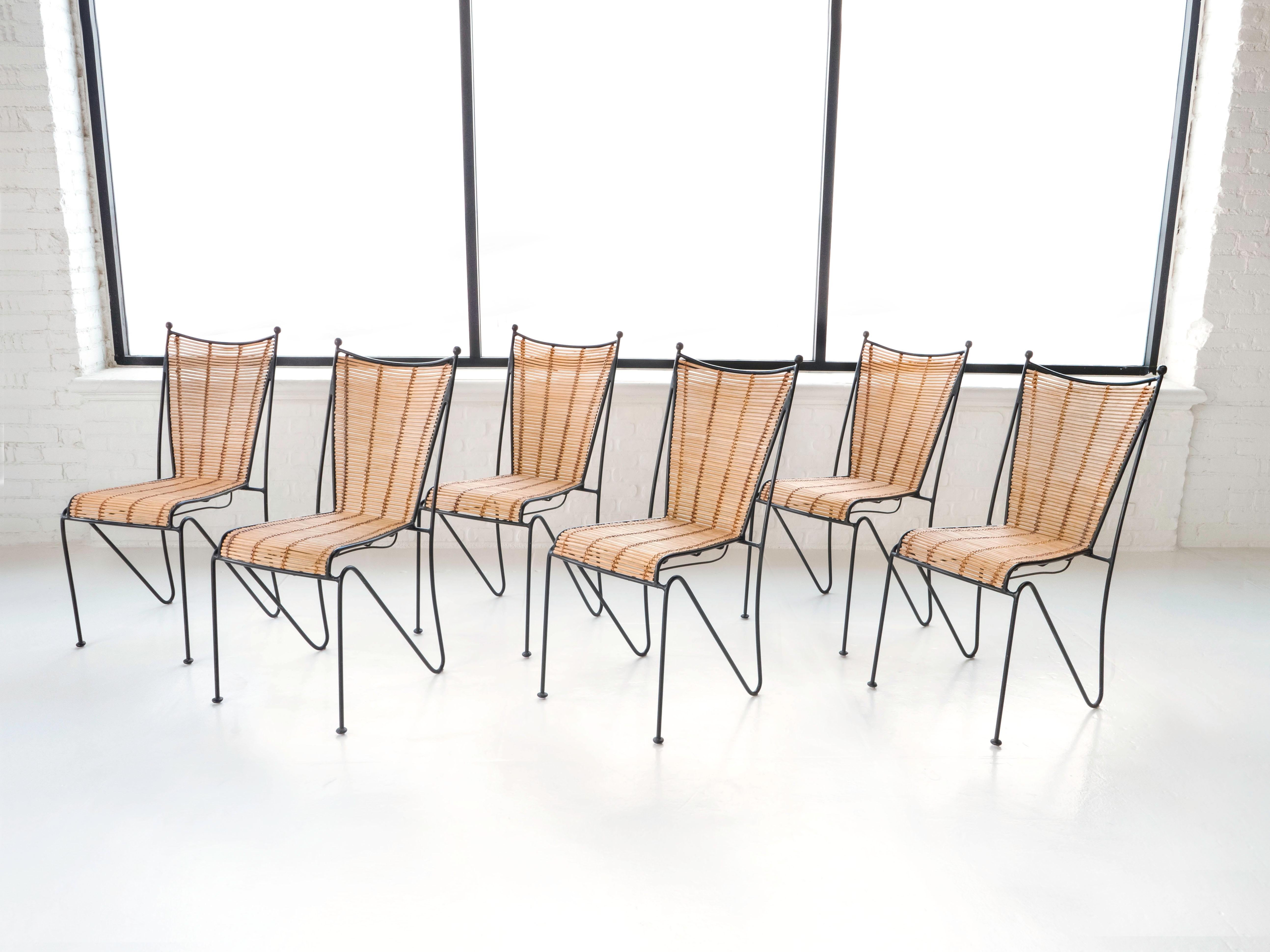 Set of 6 indoor / outdoor dining chairs by designer Pipsan Saarinen Swanson for Ficks Reed. Made out of welded iron frames and rattan, circa 1950s. These chairs are in very nice original condition. 

The chairs show patina with no breaks in the