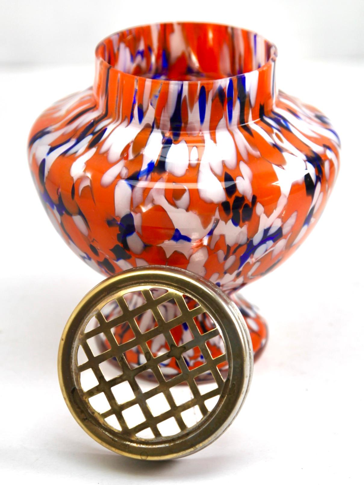 Dramatic multi color decor, cobalt and orange, in hand blown splatter glass vase in the Art Deco style. This design for vases is often called 'Pique fleurs' or 'rose-bowl' and is supplied with a fitted metal grille (possibly a later replacement) to