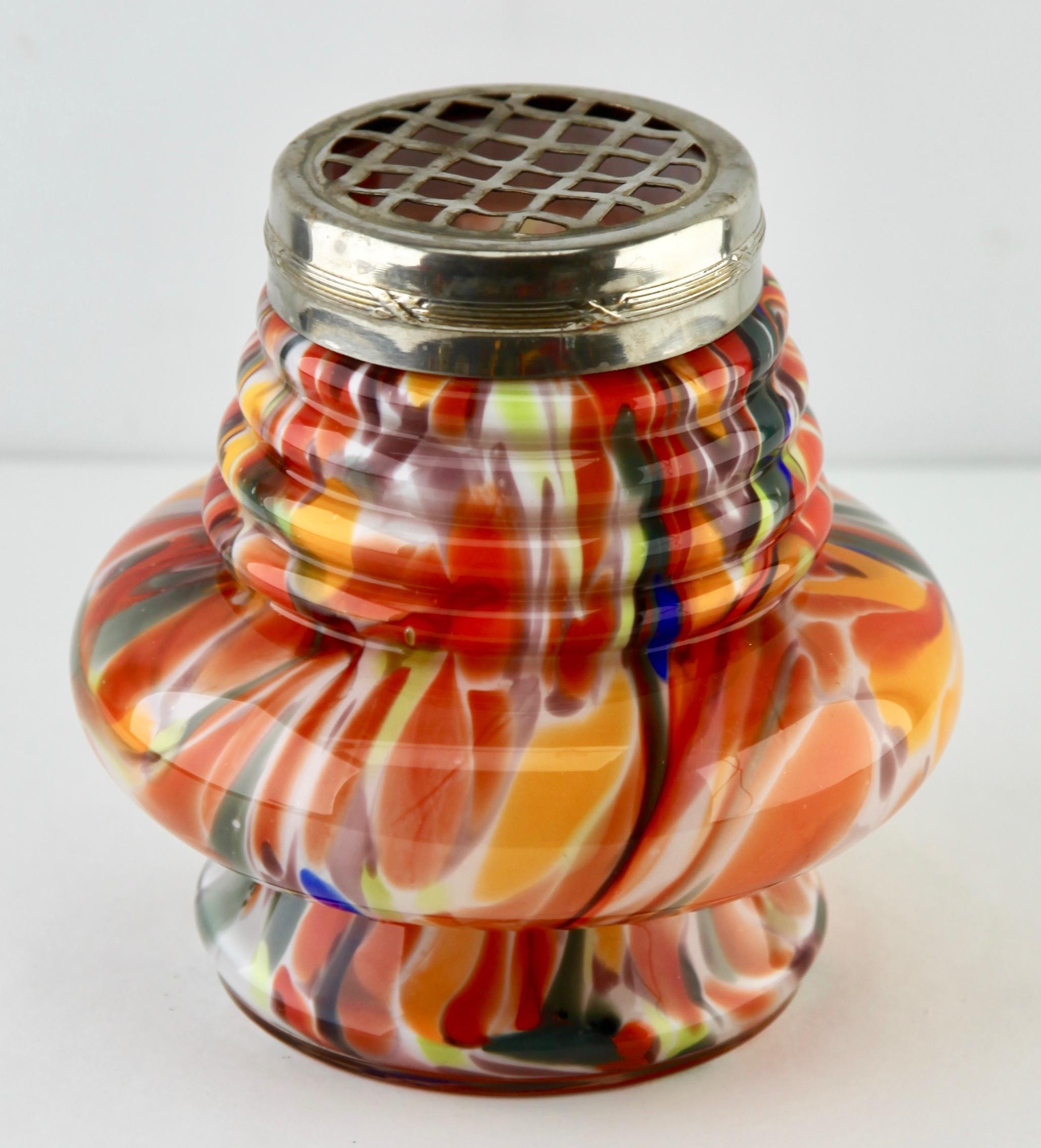 Startling spatter vase with multicolored colors, in hand blown splatter glass vase in the Art Deco style.
This design for vases is often called 'Pique fleurs' or 'rose-bowl' and is supplied with a fitted metal grille to support stems in an